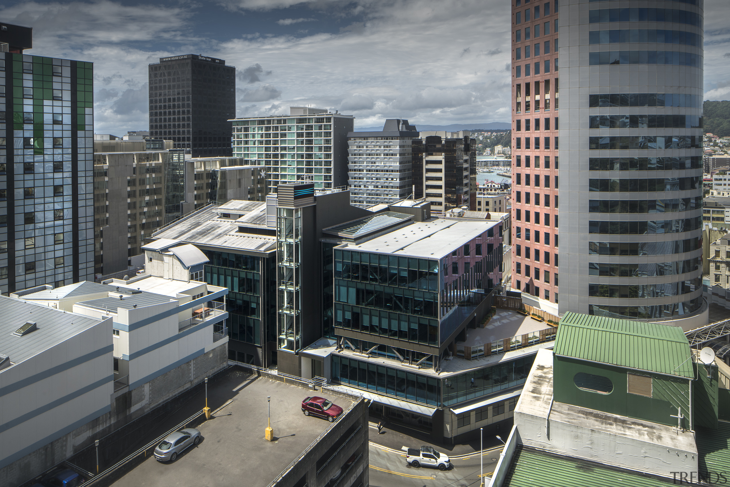 A grouping of adjacent inner-city buildings with an architecture, building, city, cityscape, condominium, corporate headquarters, daytime, downtown, metropolis, metropolitan area, mixed use, real estate, roof, skyline, skyscraper, tower block, urban area, gray, black