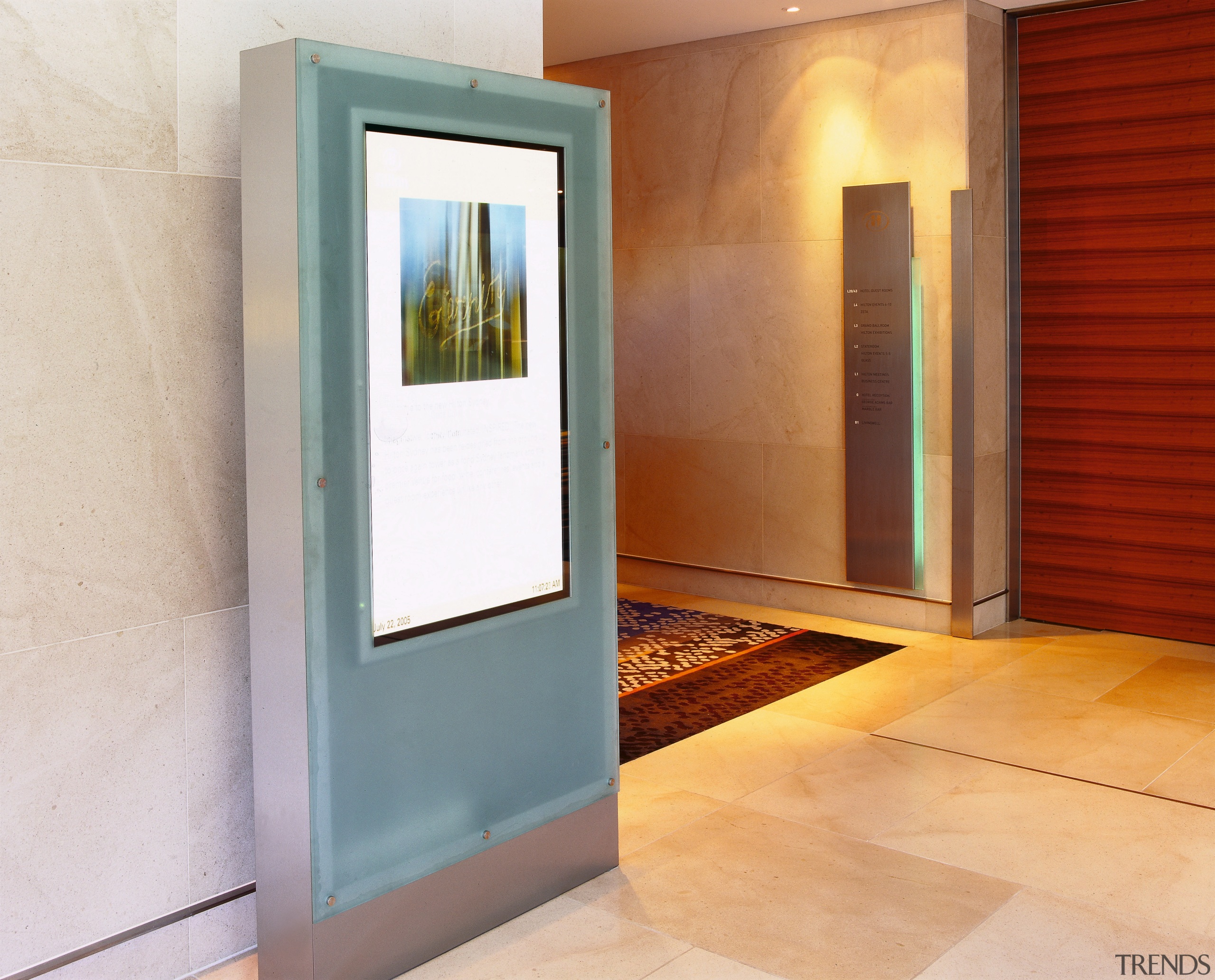 View of digital signage system in hotel lobby. door, floor, home, interior design, property, real estate, wall, window, gray