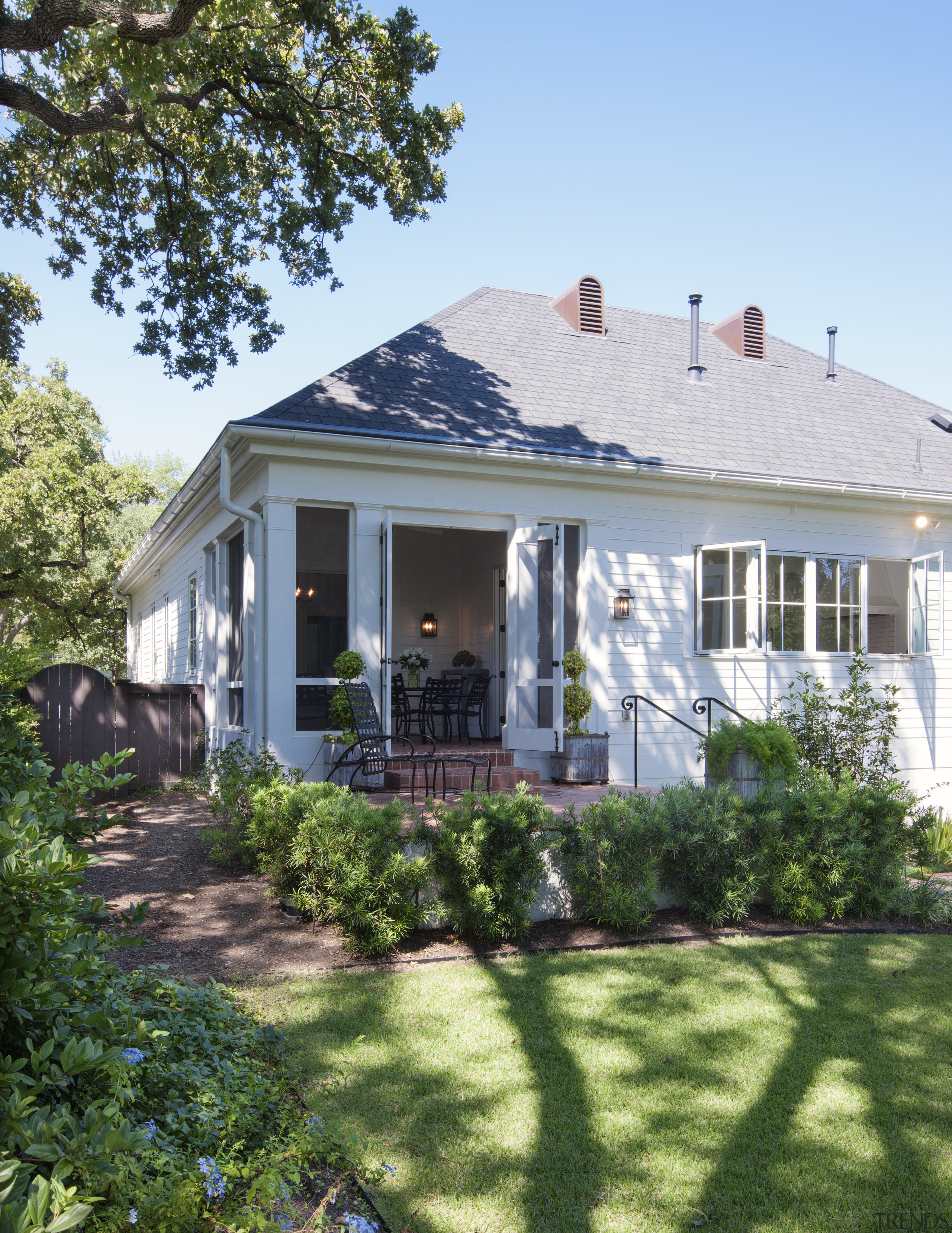 A steeply pitched gable roof and traditional detailing backyard, cottage, estate, facade, farmhouse, home, house, outdoor structure, porch, property, real estate, roof, siding, window, yard, teal, green