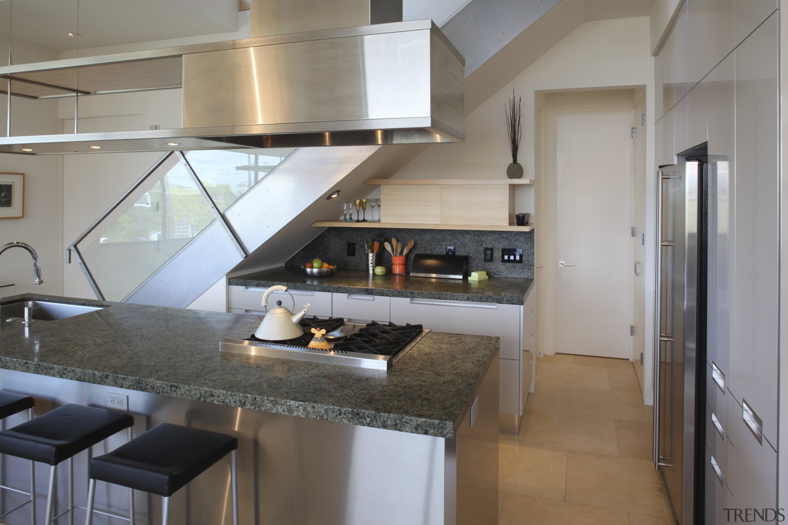 View of a small kitchen beneath a stairway cabinetry, countertop, cuisine classique, interior design, kitchen, gray