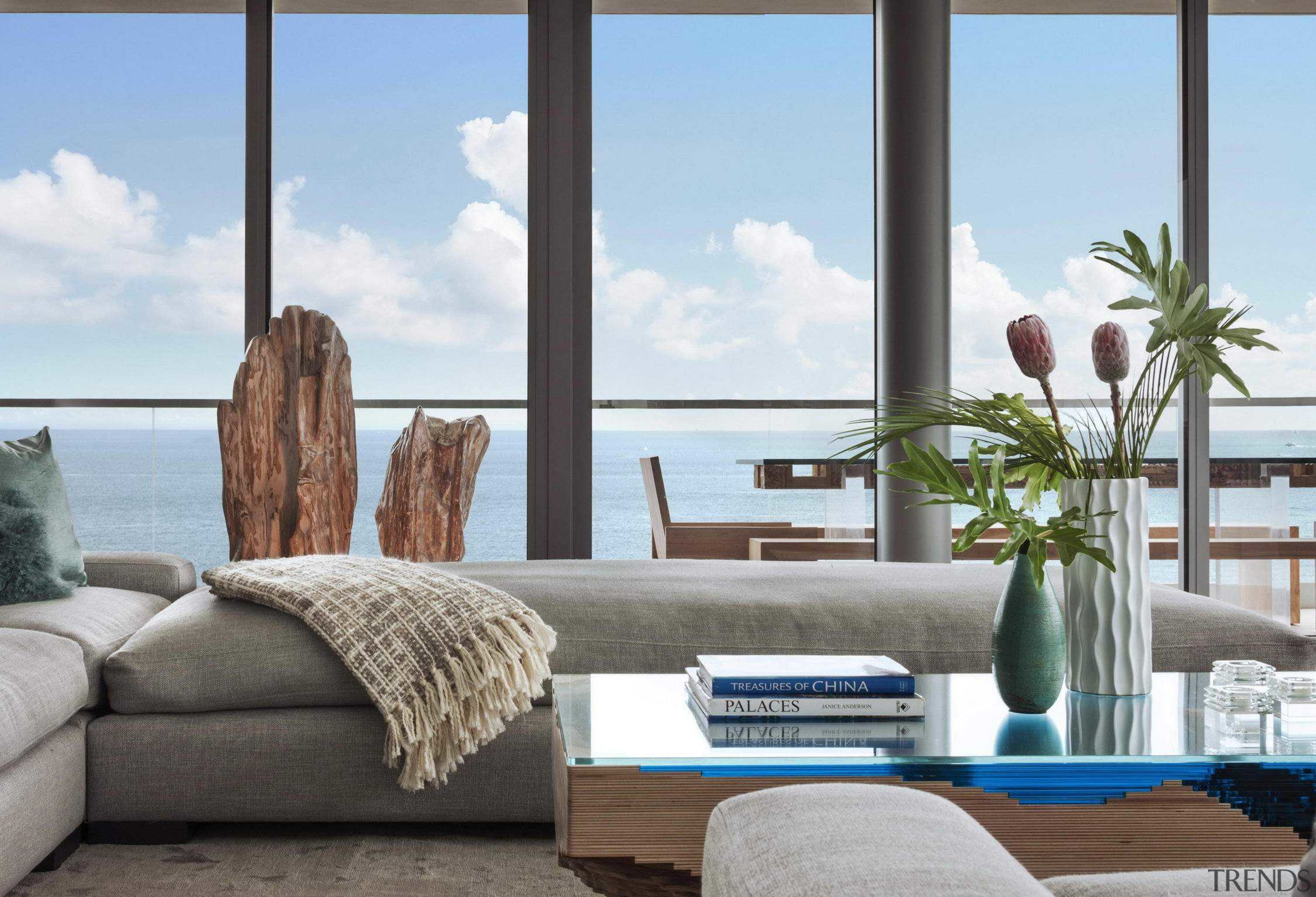 Contemporary, understated interior design in neutral colours contributes azure, building, coffee table, couch, furniture, home, house, interior design, living room, ocean, property, real estate, room, shade, studio couch, suite, table, vacation, window, white