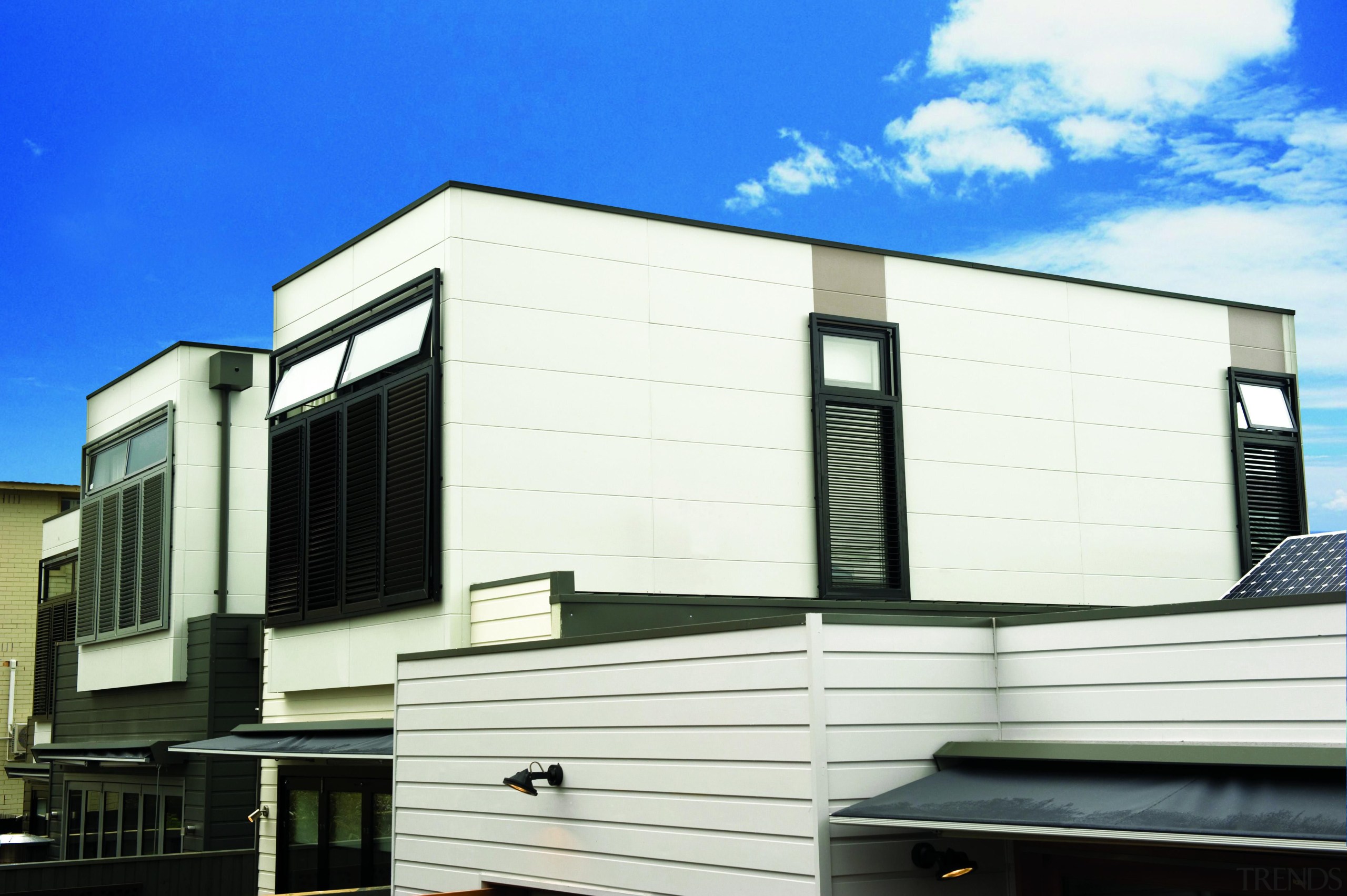 An affordable walling solution, Smooth panels provide designers architecture, building, commercial building, corporate headquarters, elevation, facade, home, house, property, real estate, residential area, siding, window, white