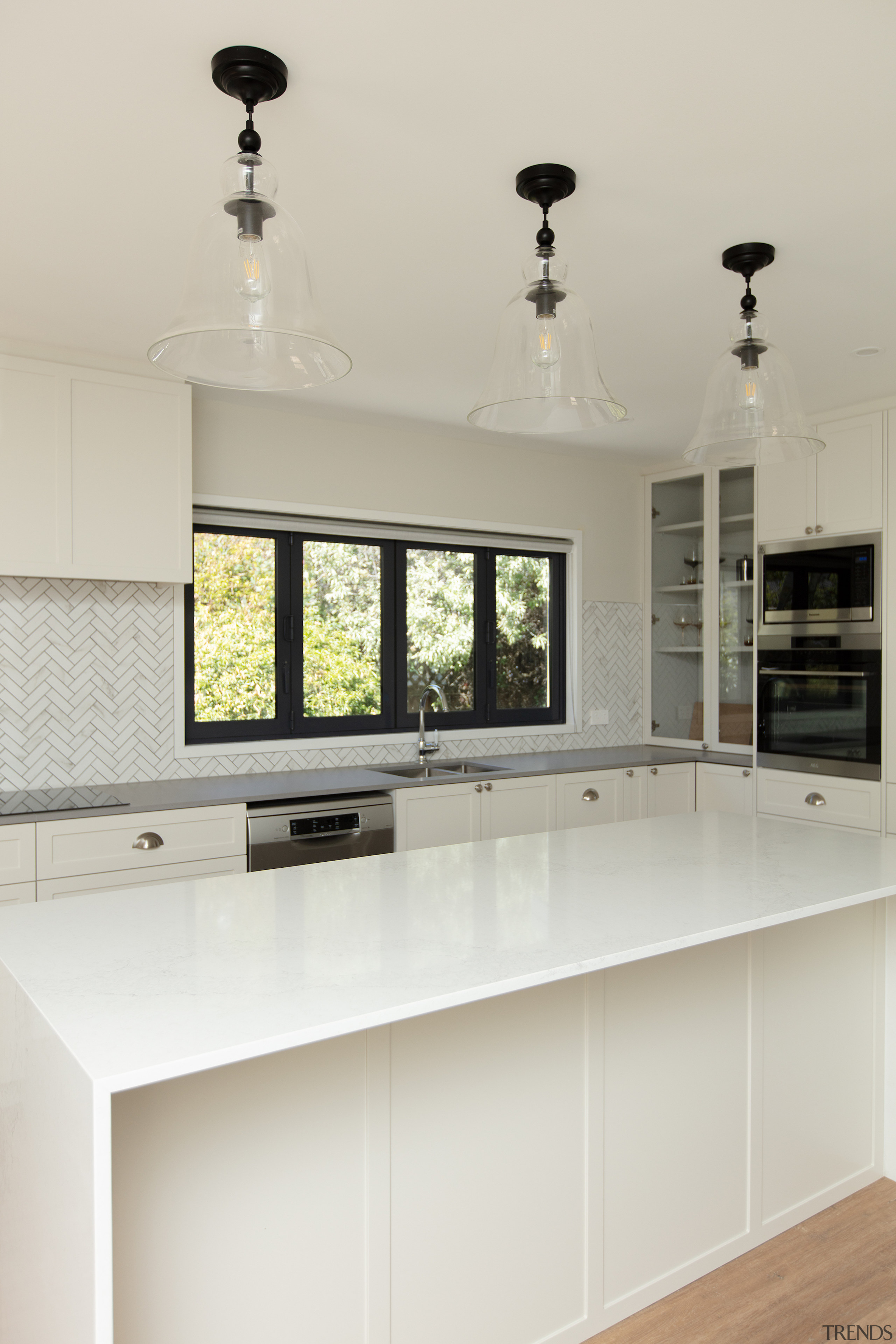 The light-toned mosaic splashbacks together with new white, 