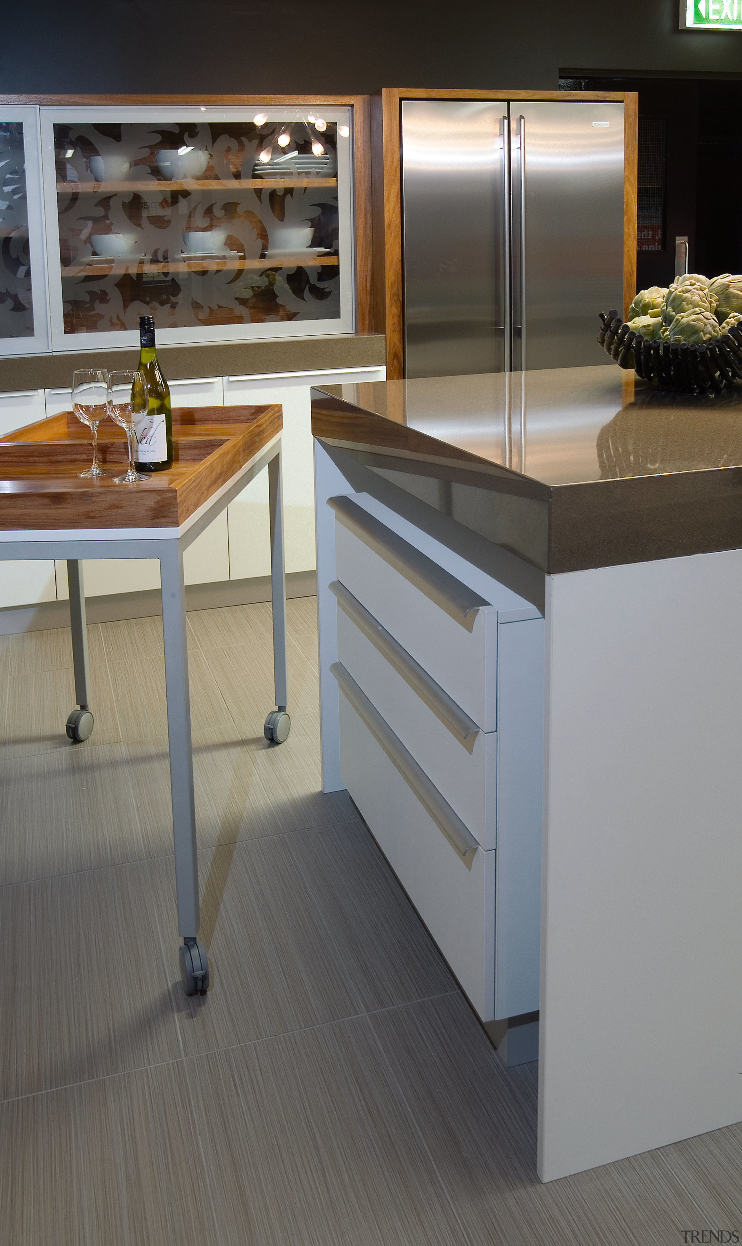 A view of these kitchens designed by Yellowfox cabinetry, countertop, floor, flooring, furniture, hardwood, kitchen, laminate flooring, table, wood, wood flooring, gray, black