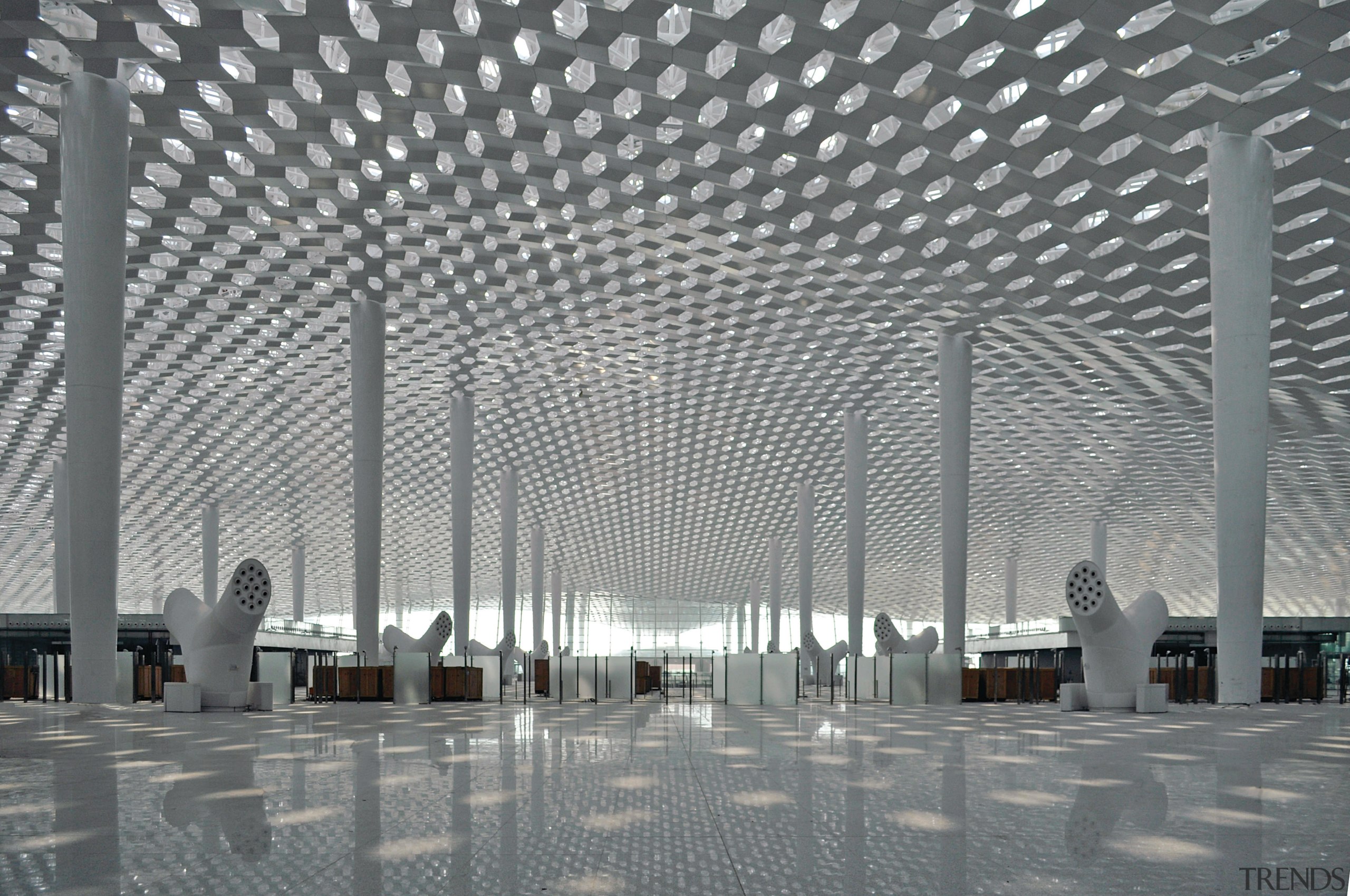 Looking much like a giant sculpture from both airport terminal, architecture, building, ceiling, convention center, daylighting, facade, line, metropolis, metropolitan area, structure, symmetry, gray