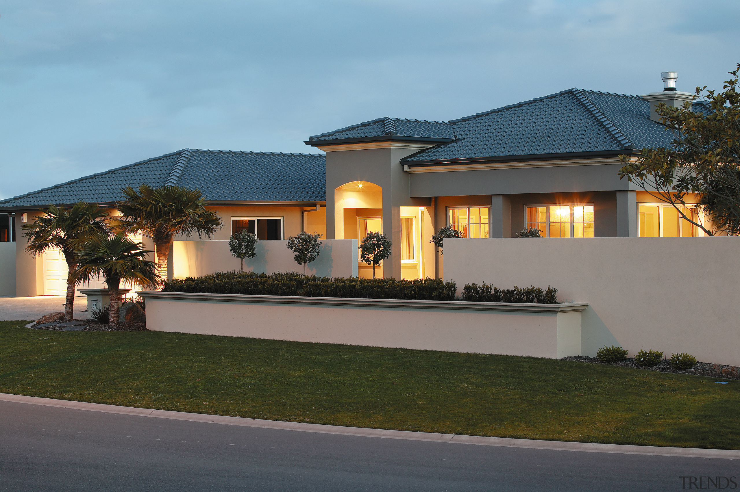 A view of a house by Harwood Homes. architecture, building, elevation, estate, facade, home, house, mansion, official residence, property, real estate, residential area, roof, villa, window, teal, gray