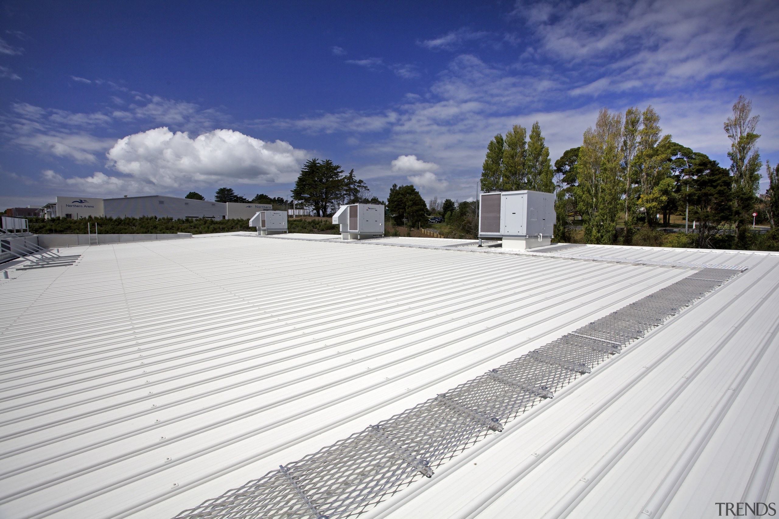 The Silverdale Centre roof was installed by Kiwi architecture, asphalt, cloud, daylighting, house, line, outdoor structure, real estate, road surface, roof, sky, white, blue