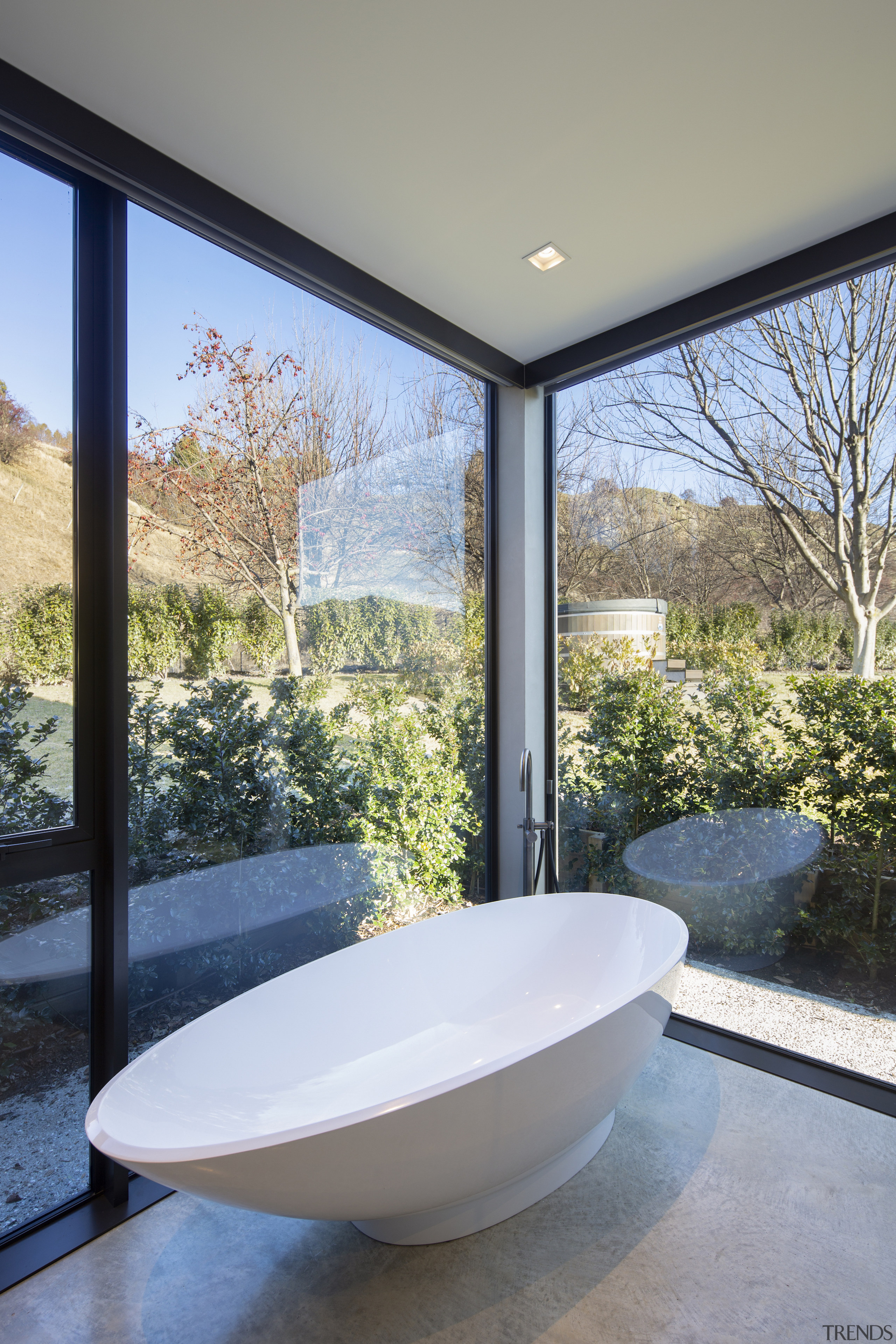 A comfortable tub, underfloor heating and giant windows 
