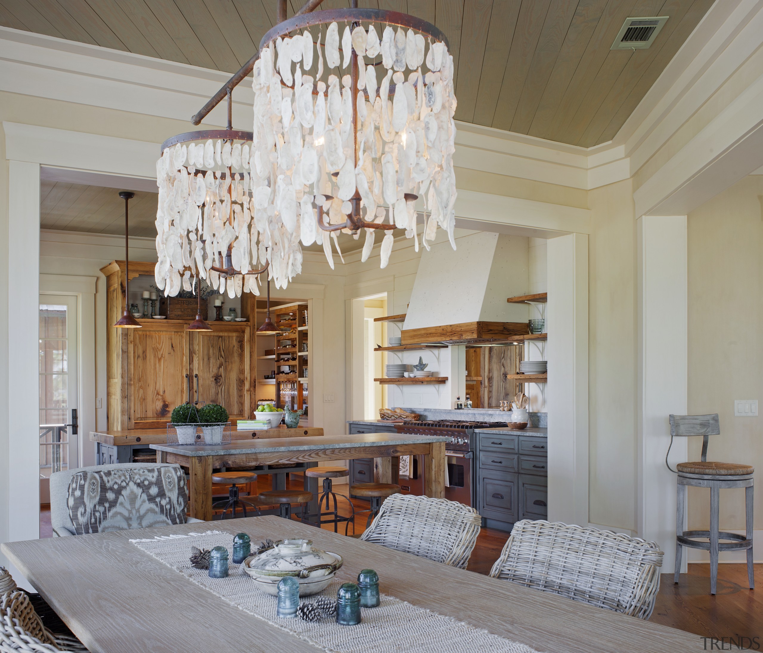 The dining area of this family room includes ceiling, chandelier, dining room, home, interior design, living room, real estate, room, window, gray