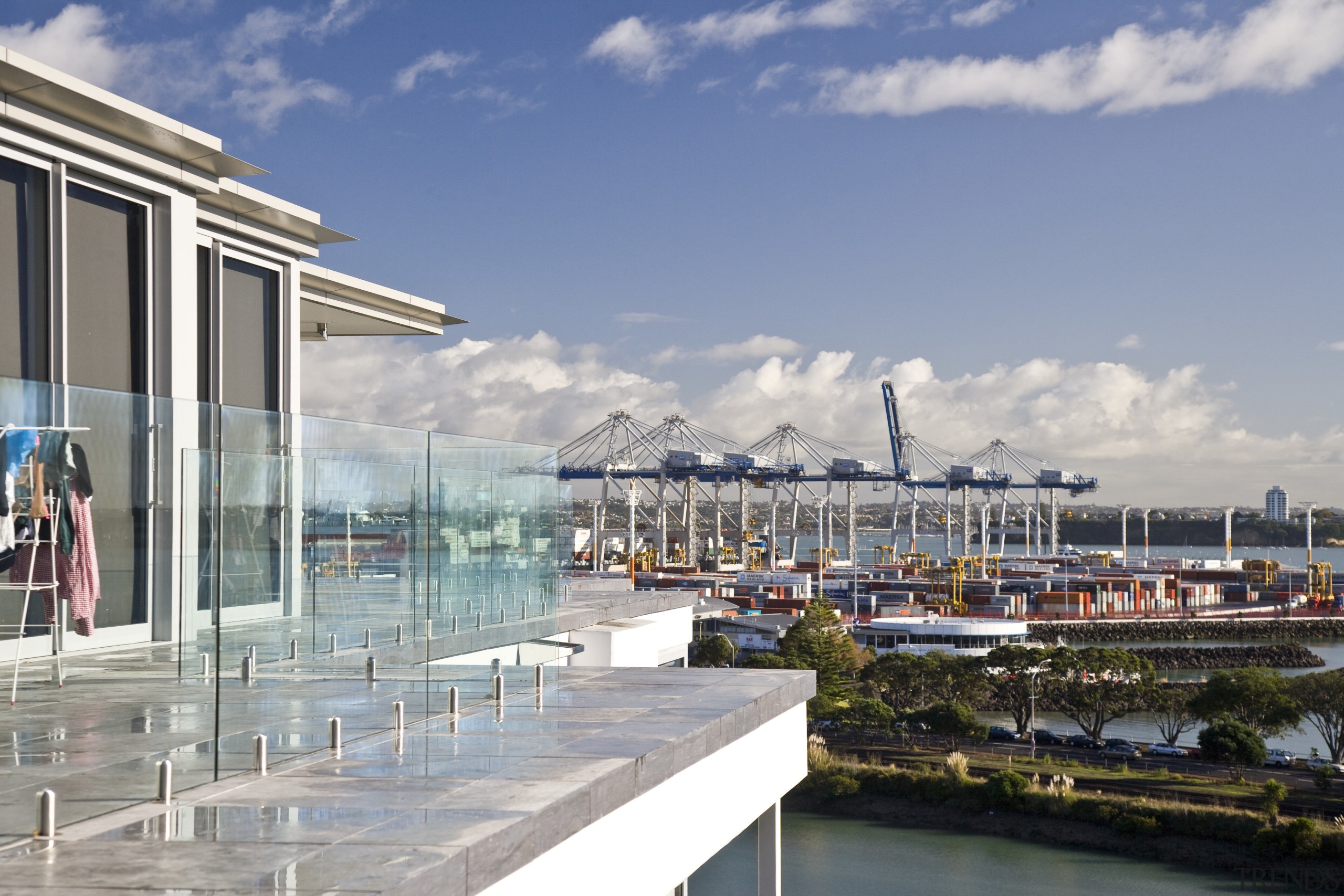 View of apartment balconies with glass balustrades. city, dock, marina, mixed use, real estate, sky, water, gray