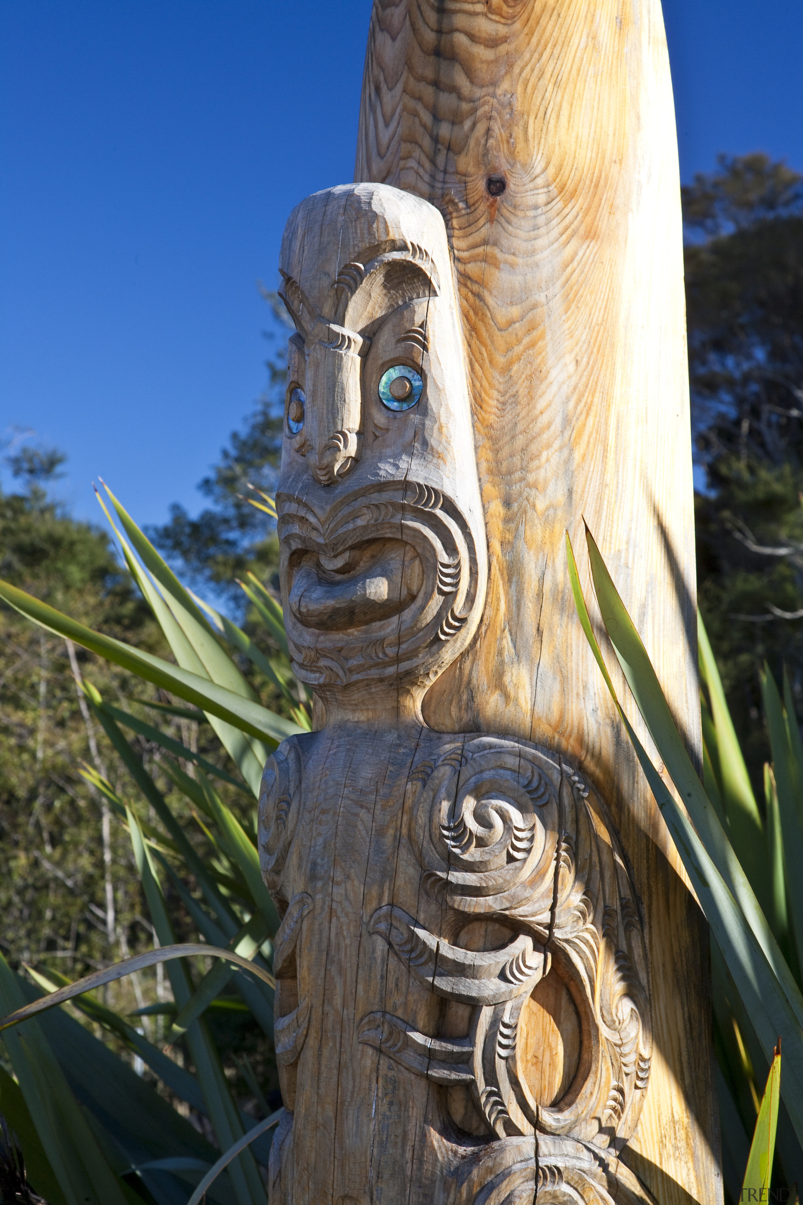 Close-up view of the garden's Maori sculpture - artifact, carving, grass, outdoor structure, sculpture, tiki, totem, totem pole, tree