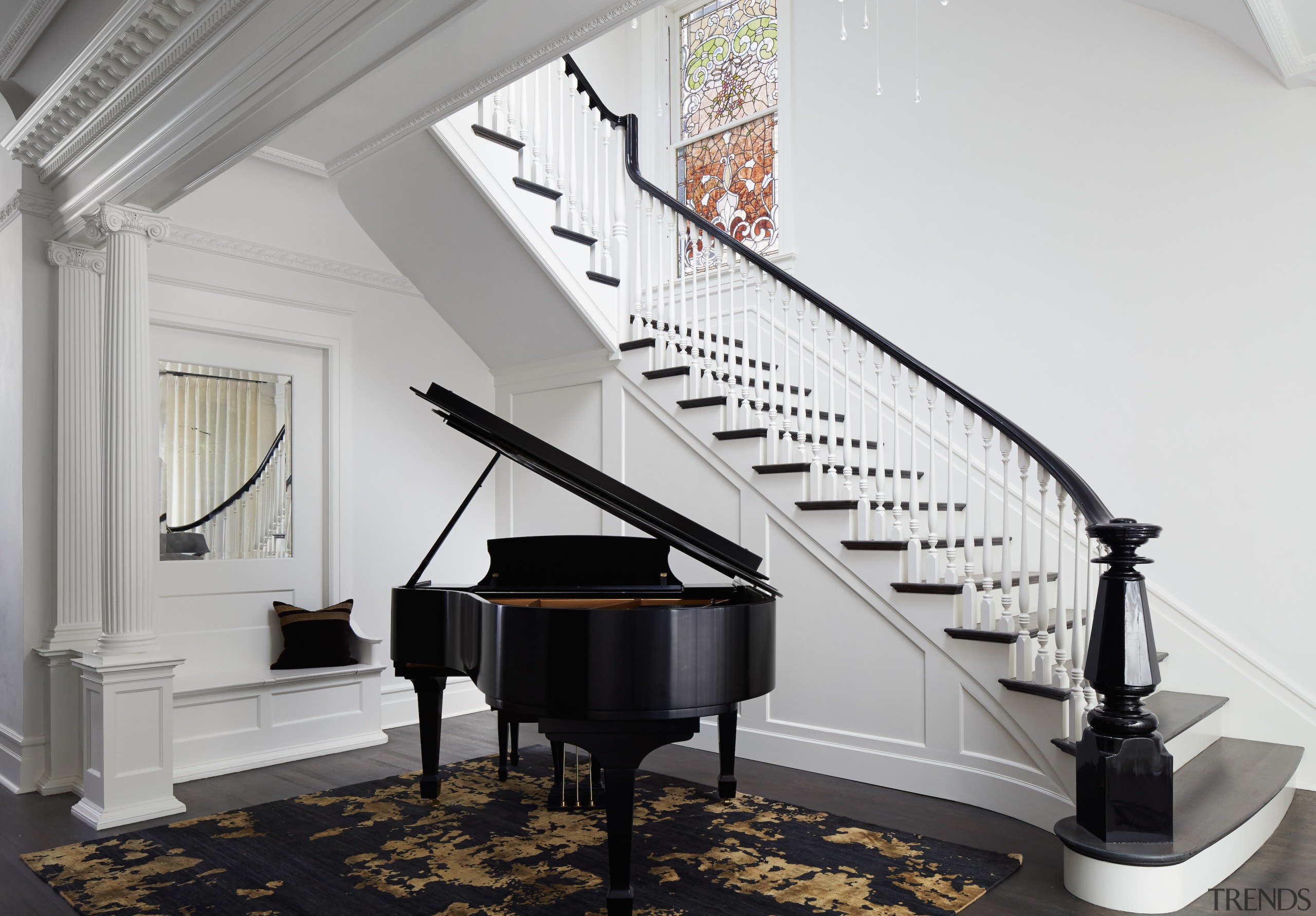 Grand piano meets grand staircase in the entry 