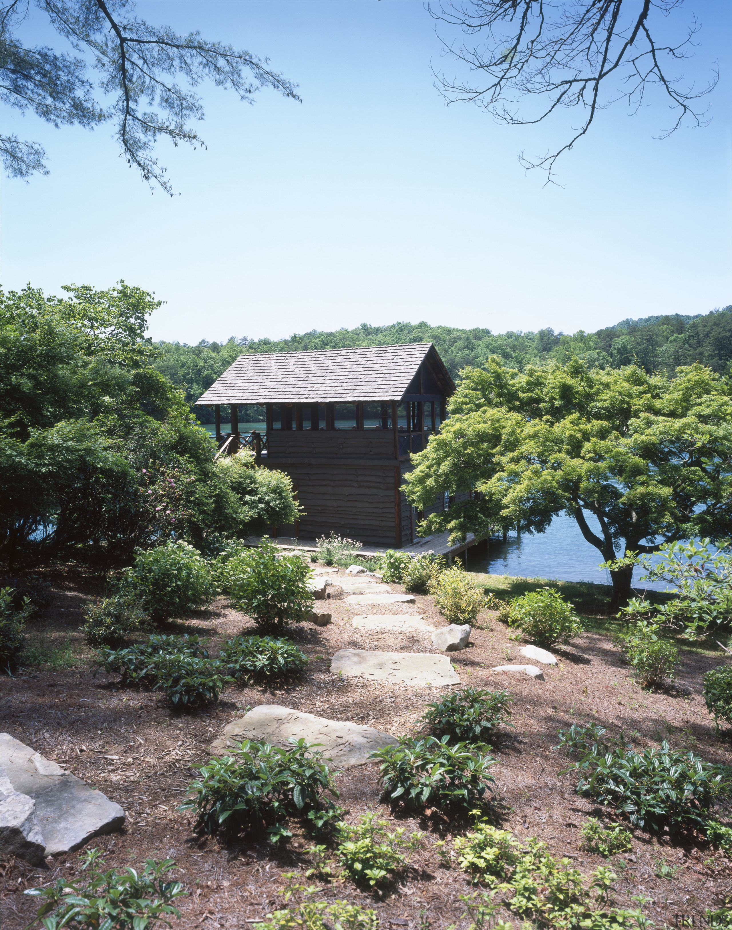 A boathouse built after the fashion of the estate, garden, hill station, home, house, landscape, plant, real estate, rural area, sky, tree, vegetation