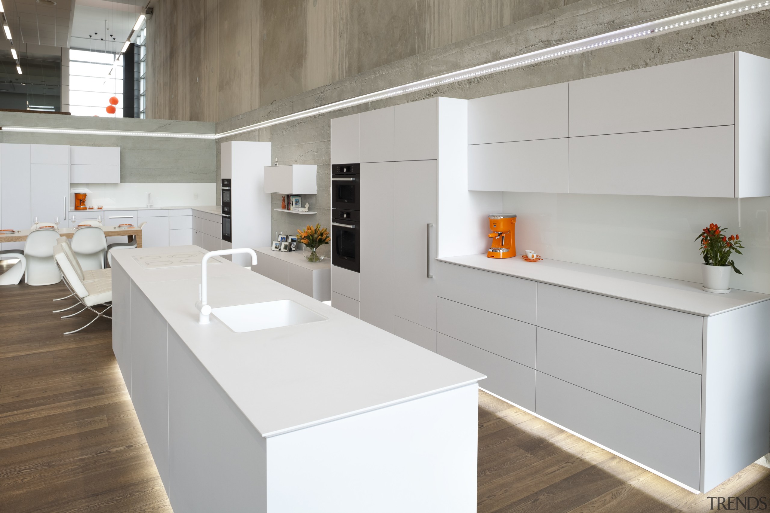Showroom kitchen with white cabinetry and wooden flooring. cabinetry, countertop, cuisine classique, furniture, interior design, kitchen, product design, gray