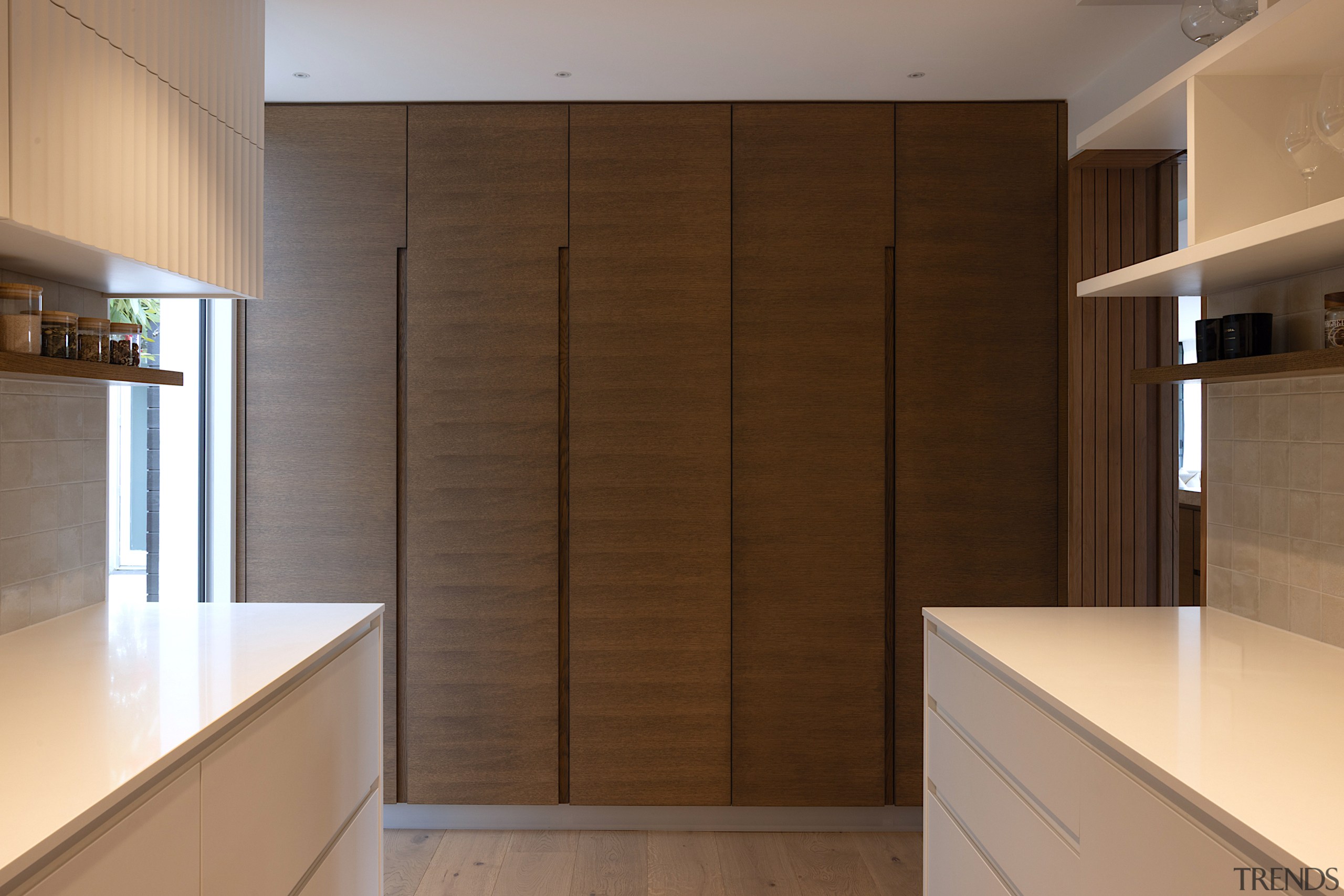 Handleless, integrated cabinetry gives the kitchen a seamless 