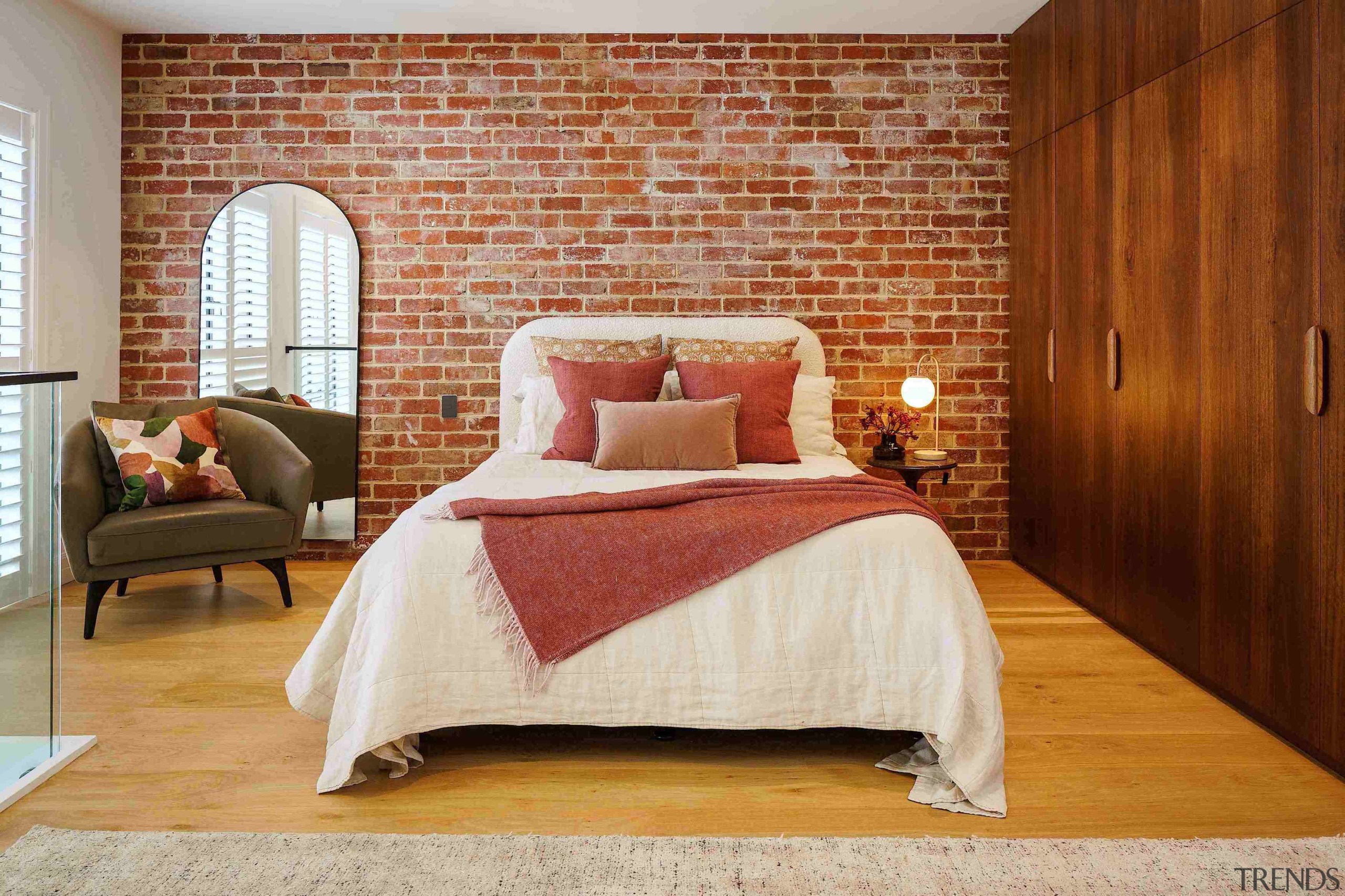Master bedroom with feature brickwork and built-in custom 