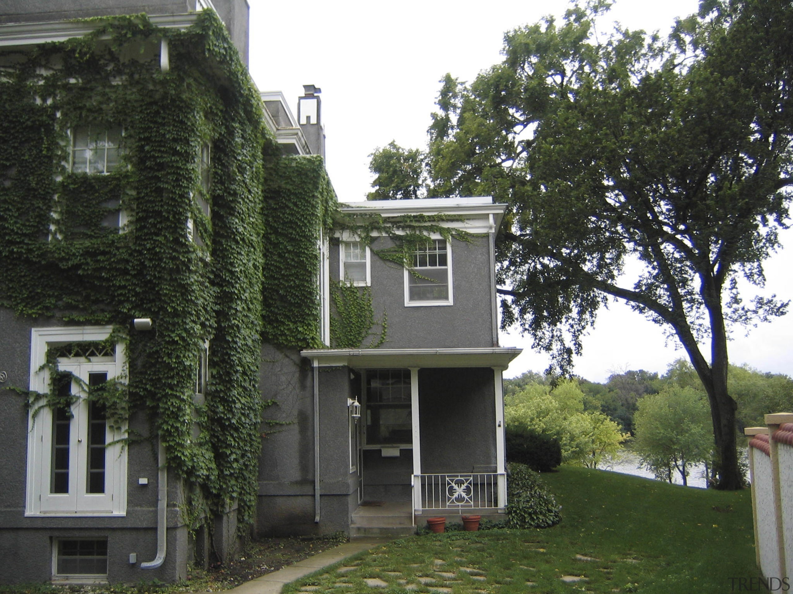 View of a multi-storey grey house with swimming architecture, building, cottage, estate, facade, historic house, home, house, mansion, neighbourhood, plant, property, real estate, residential area, tree, black