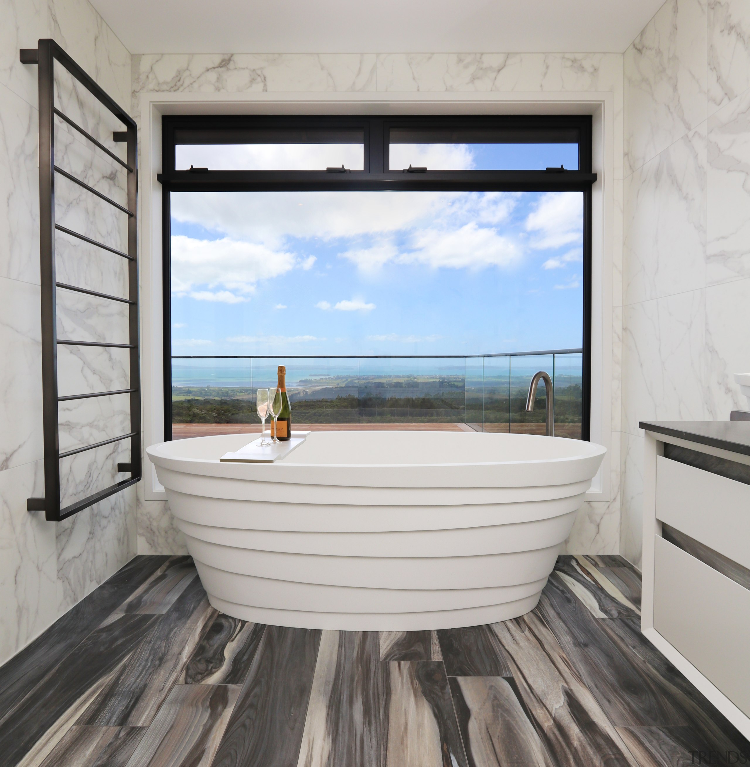 A freestanding Idaho stone bath is a feature architecture, blue, building, ceiling, daylighting, floor, flooring, furniture, hardwood, home, house, interior design, laminate flooring, living room, property, real estate, room, sea, sky, wall, window, wood, wood flooring, gray