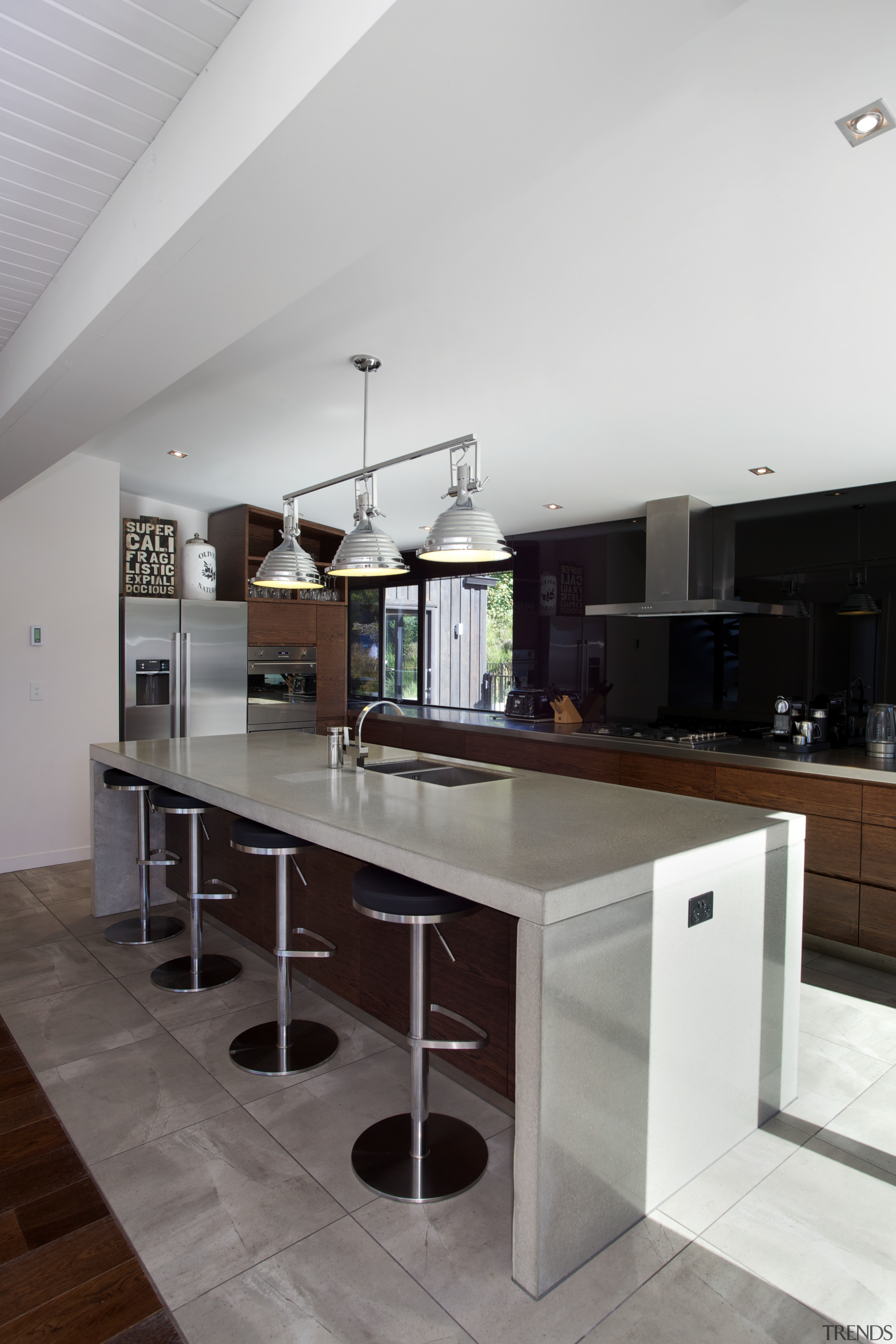 The clean-lined kitchen in this renovated home has architecture, ceiling, countertop, floor, house, interior design, kitchen, table, white, gray