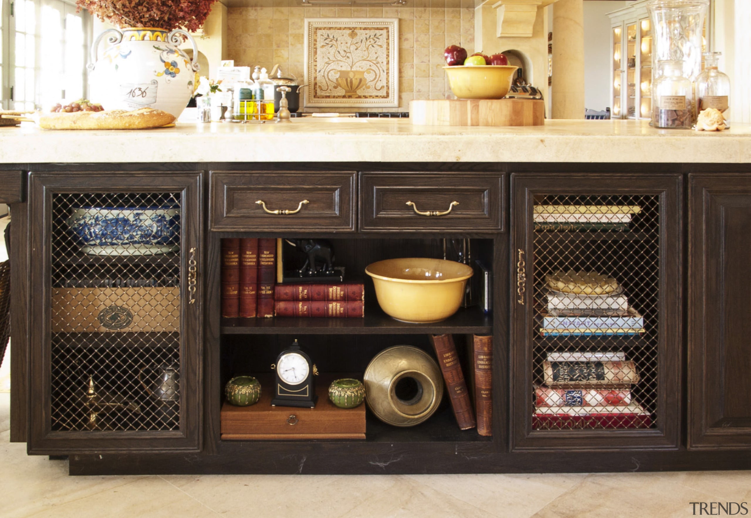 The island in this French kitchen features decorative cabinetry, furniture, black