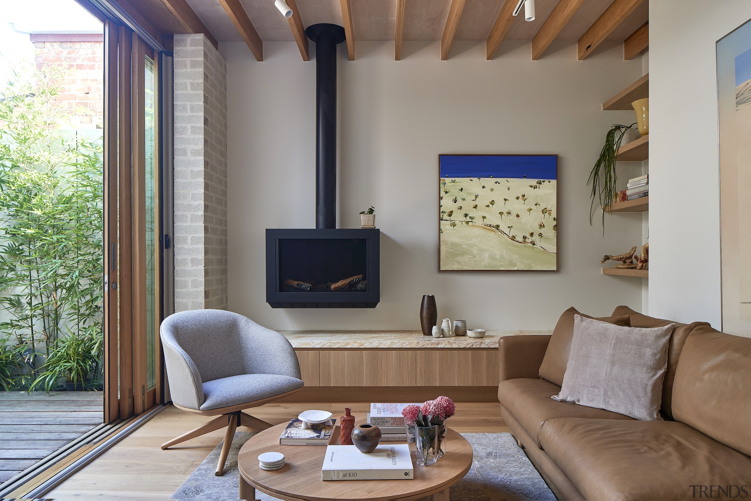 Living room with feature ceiling and wall-mounted wood 