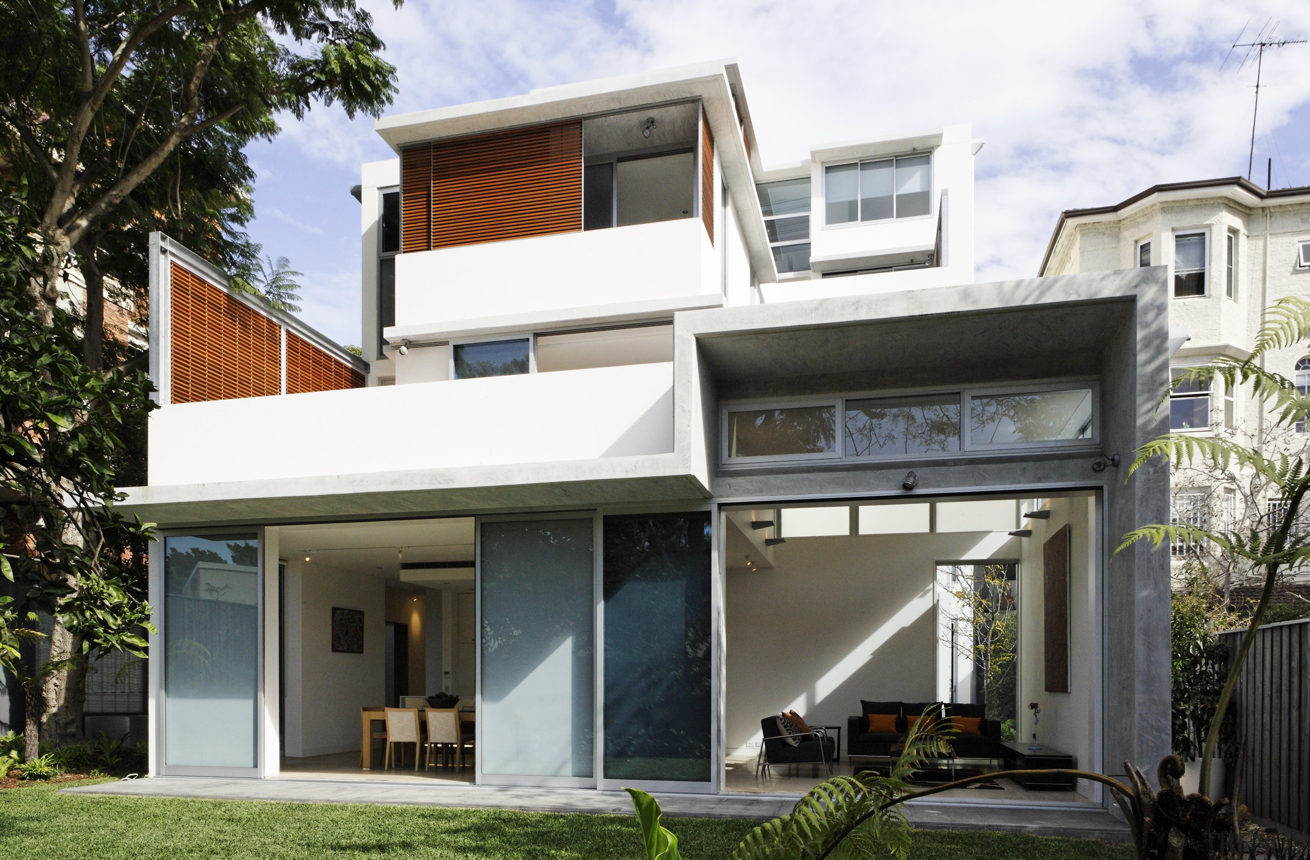 Exterior view of a three unit development designed architecture, building, elevation, facade, home, house, property, real estate, residential area, roof, window, white