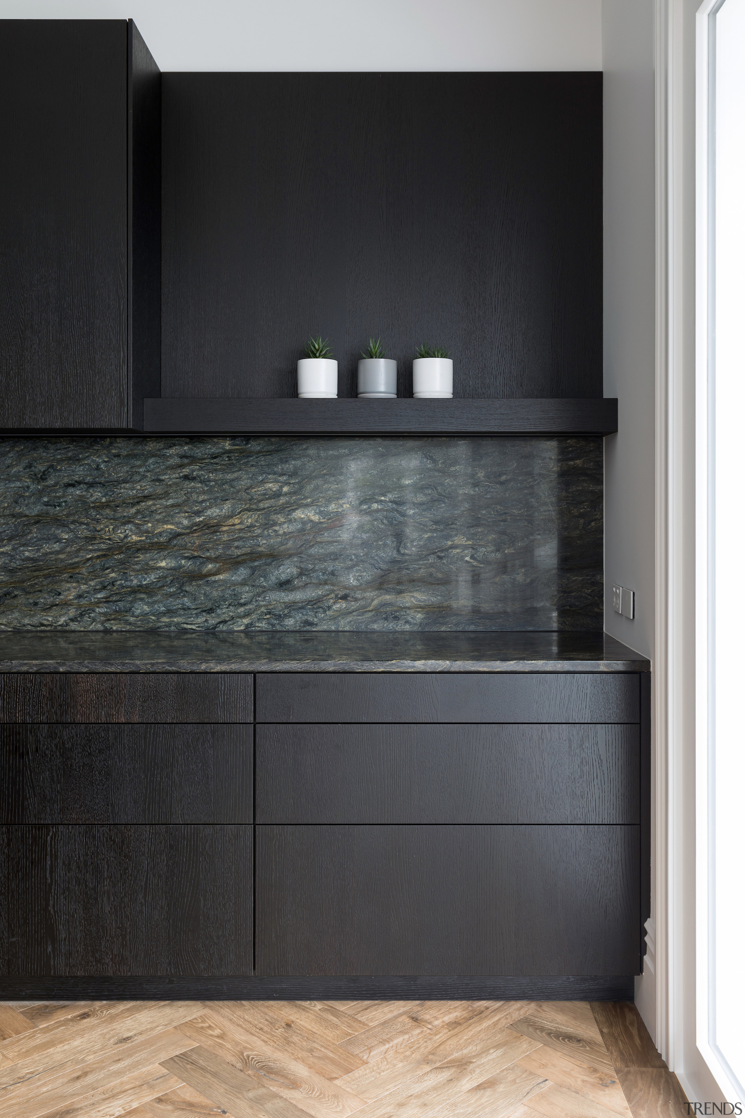 The Fusion granite benchtops turn seamlessly up the 