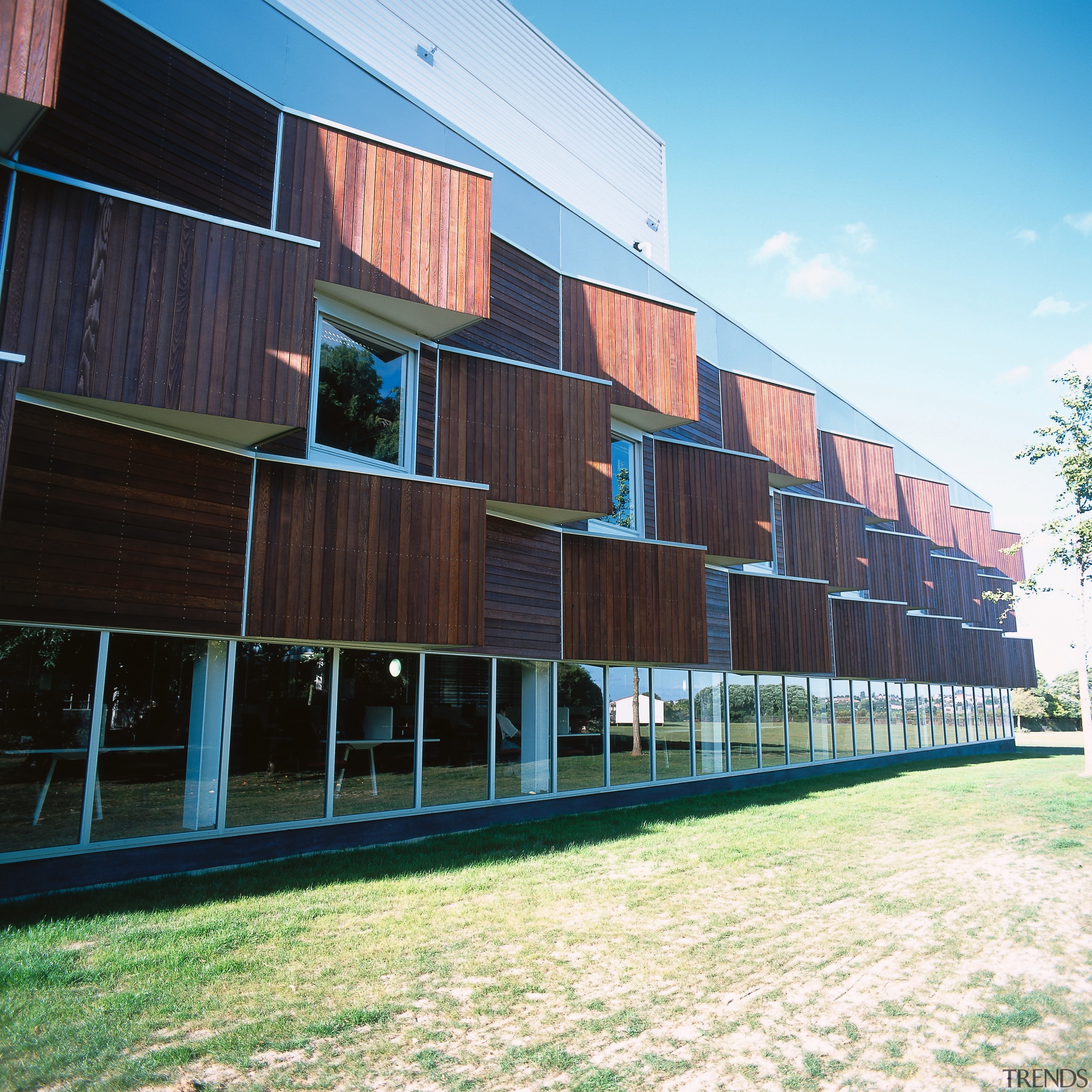 An exterior view of the library. - An apartment, architecture, building, commercial building, corporate headquarters, facade, house, real estate, residential area, siding, structure, wood, black