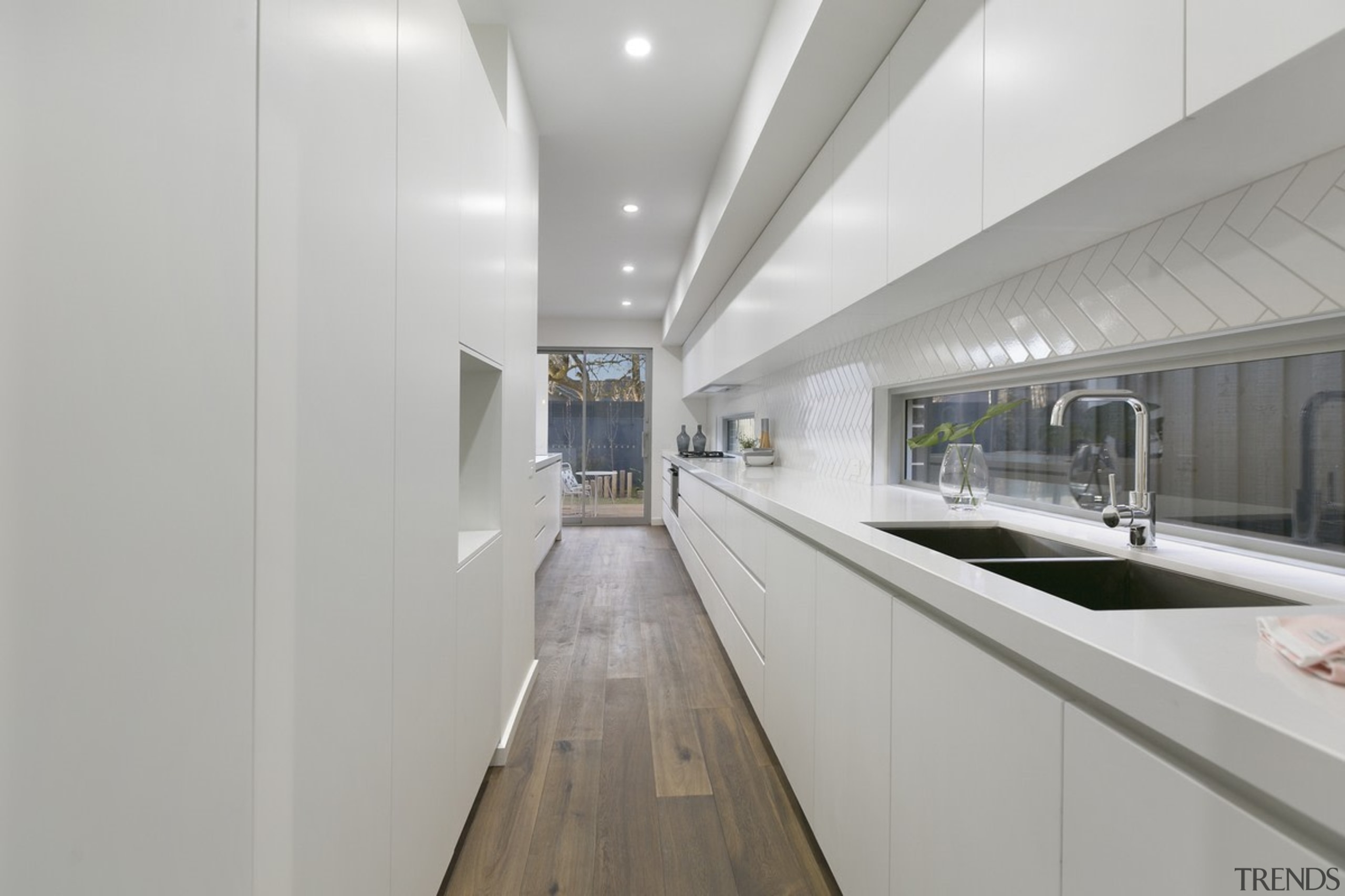 The long, white kitchen hides a scullery/work area interior design, real estate, gray