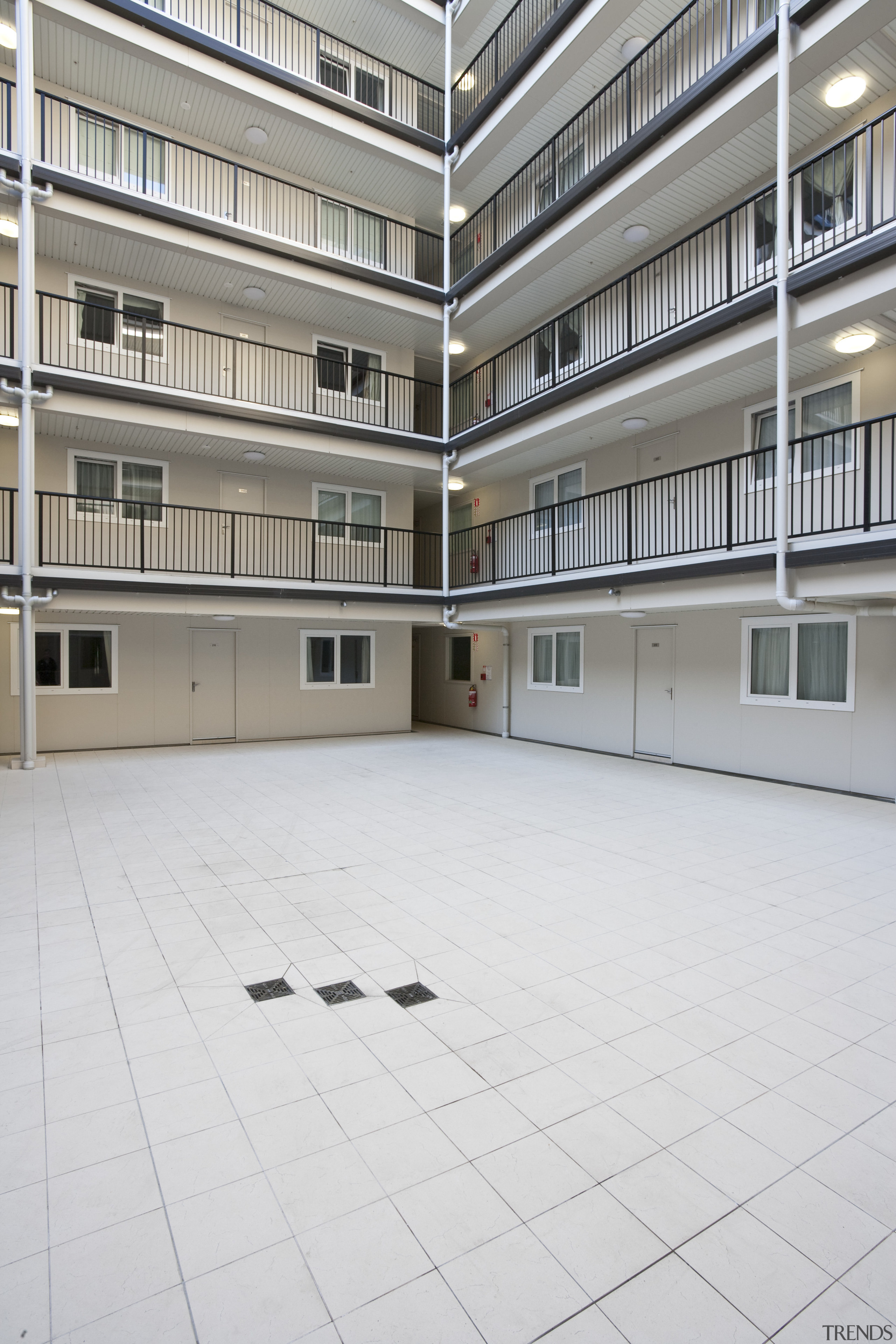 External courtyard view of kings square/Queens lodge development. apartment, architecture, building, condominium, daylighting, facade, floor, residential area, window, white, gray