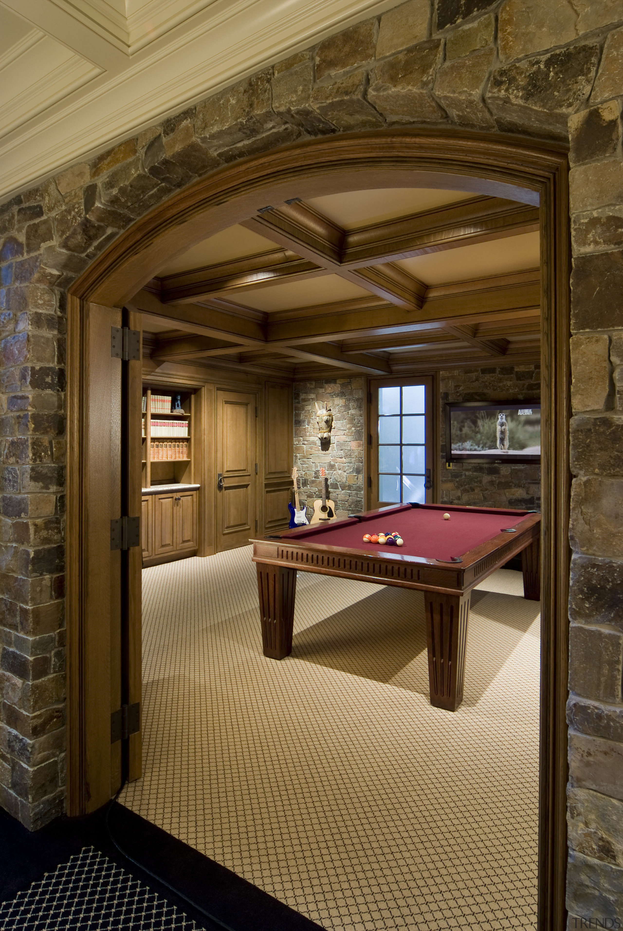 View of pool table through stone arched doorway. architecture, ceiling, estate, floor, flooring, furniture, home, interior design, room, table, wood, brown