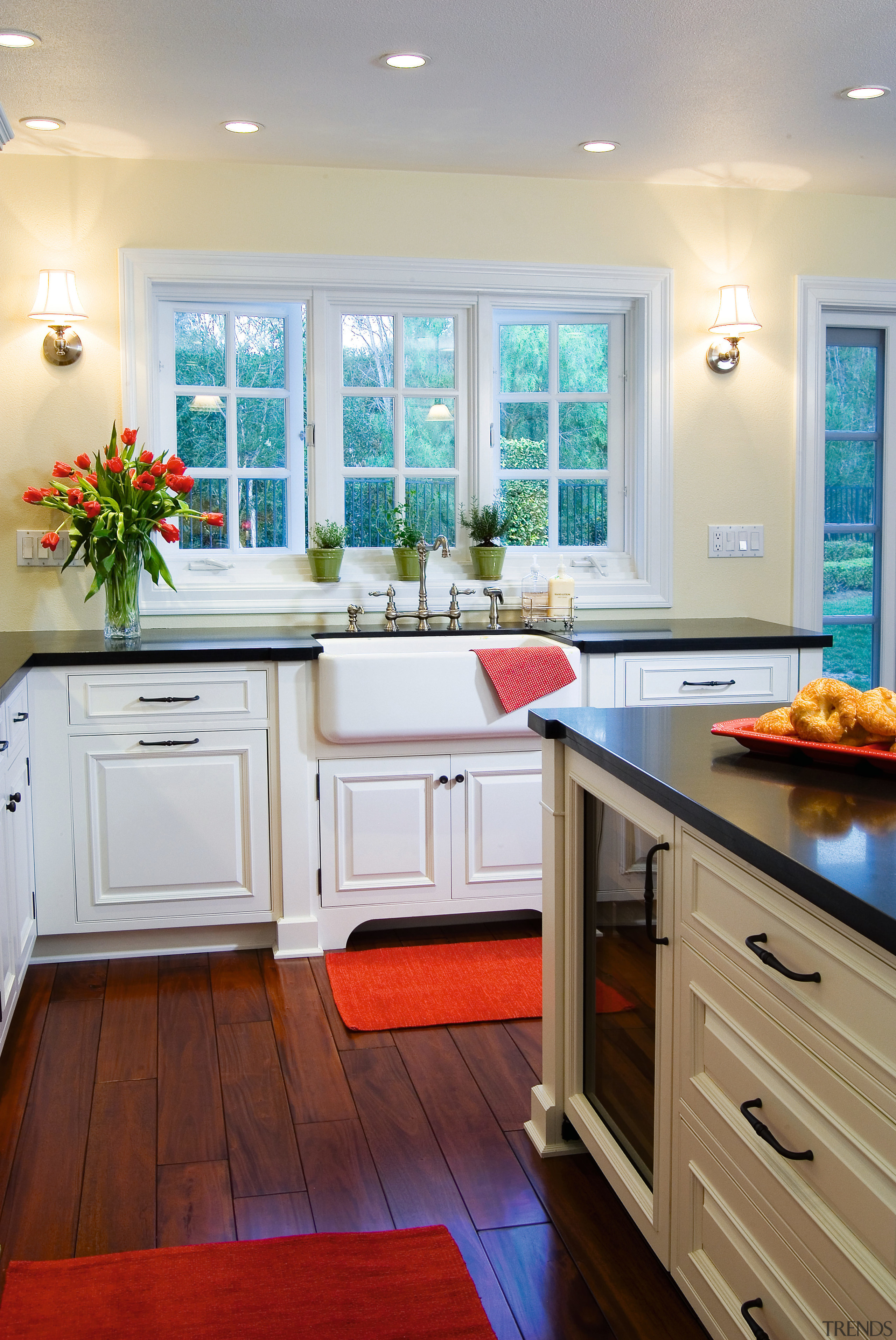 A view of this kitchen featuring white timber cabinetry, countertop, cuisine classique, floor, flooring, hardwood, home, interior design, kitchen, room, window, wood flooring, gray