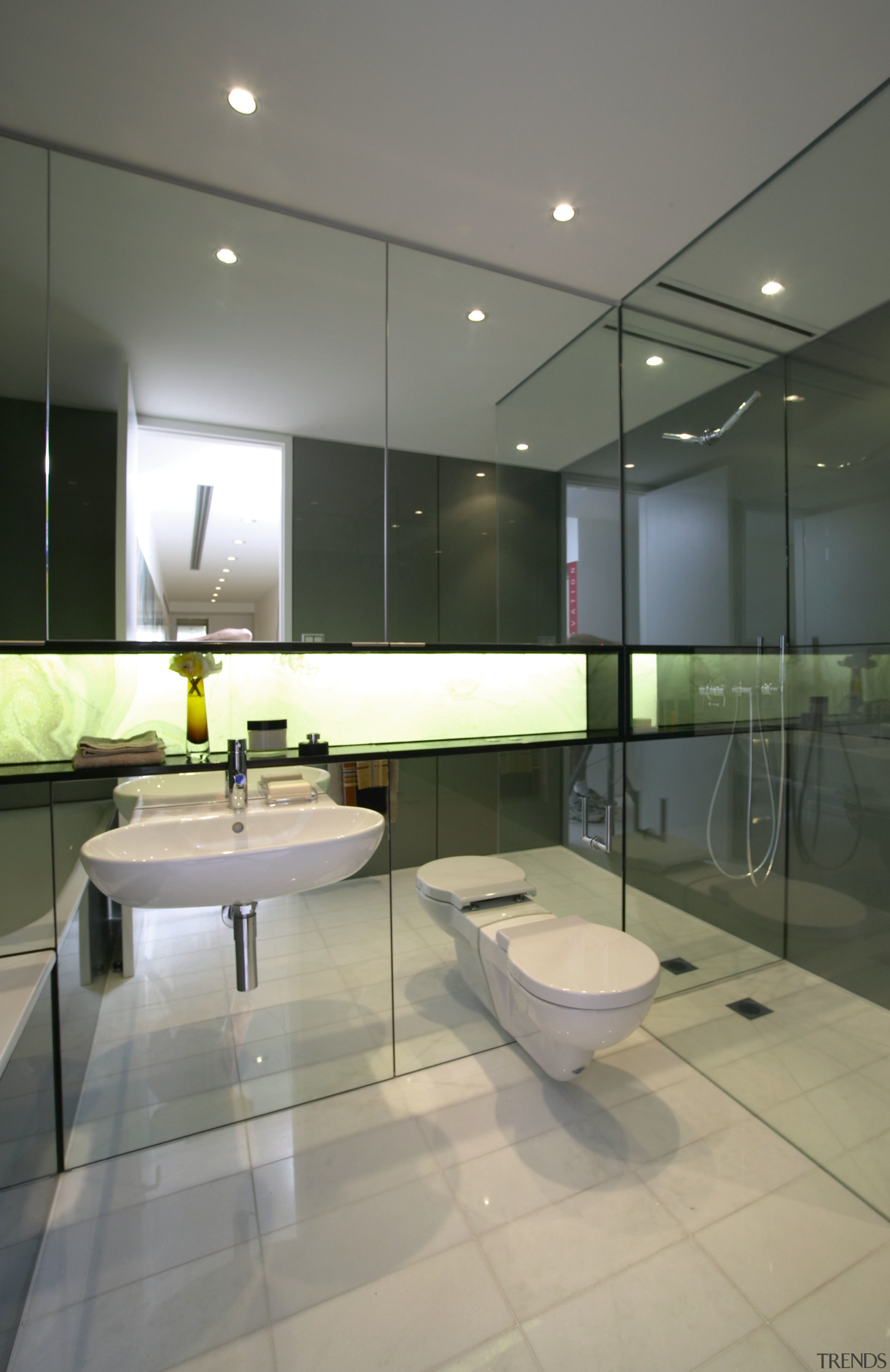 Showroom bathroom with white toilet and basin, mirrored architecture, bathroom, ceiling, floor, glass, house, interior design, real estate, sink, tile, gray