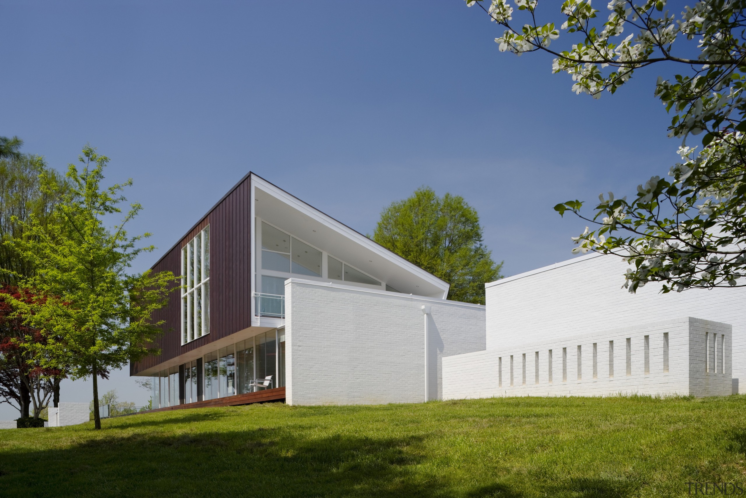 View of contemporary home. - View of contemporary architecture, corporate headquarters, cottage, daytime, elevation, facade, farmhouse, home, house, property, real estate, residential area, sky, brown