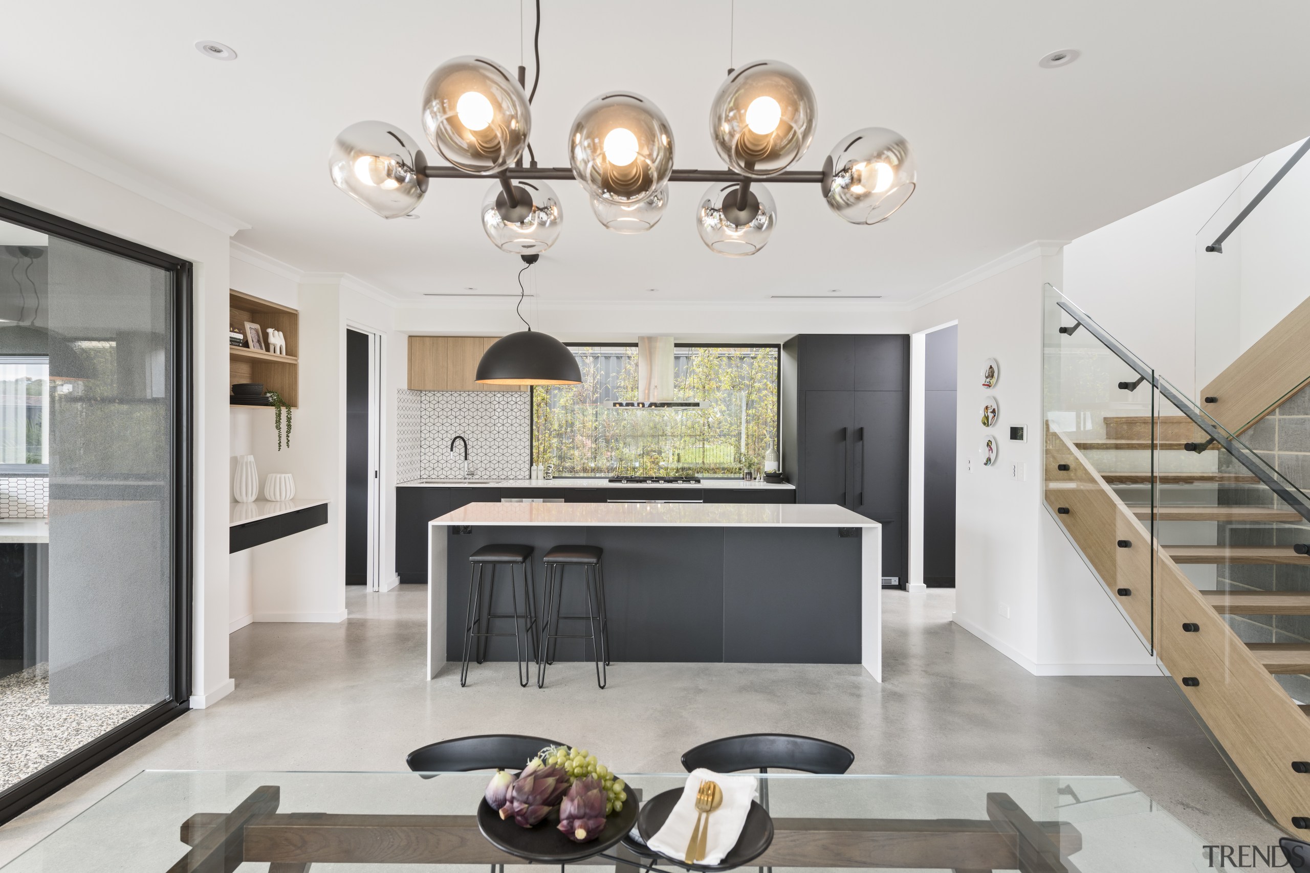 The industrial feel is matched with the polished apartment, architecture, building, cabinetry, ceiling, design, dining room, floor, flooring, furniture, home, house, interior design, light fixture, lighting, living room, loft, property, real estate, room, stairs, table, tile, wall, yellow, white, gray