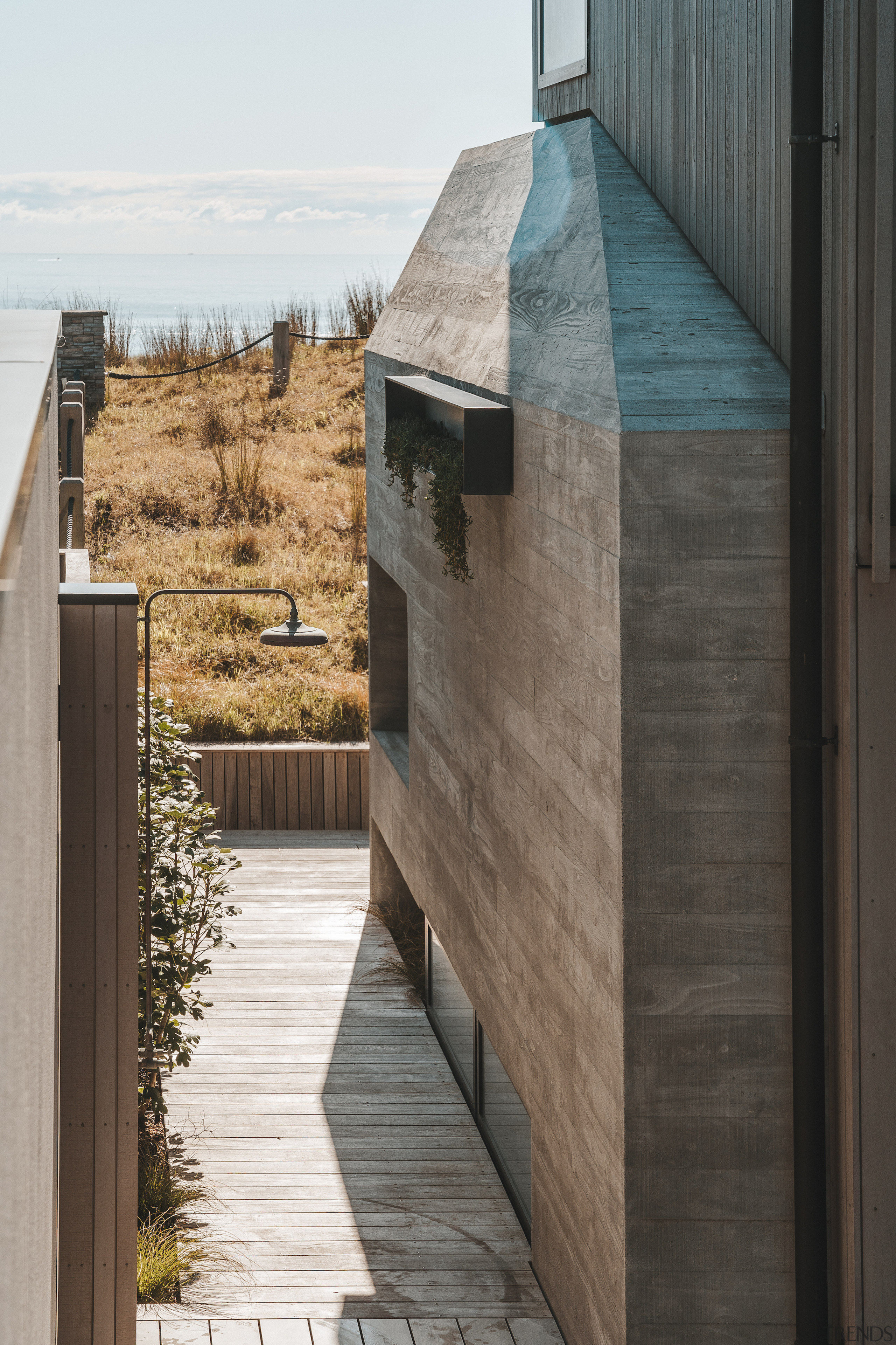 Board-formed concrete forms part of the semi-industrial cladding 