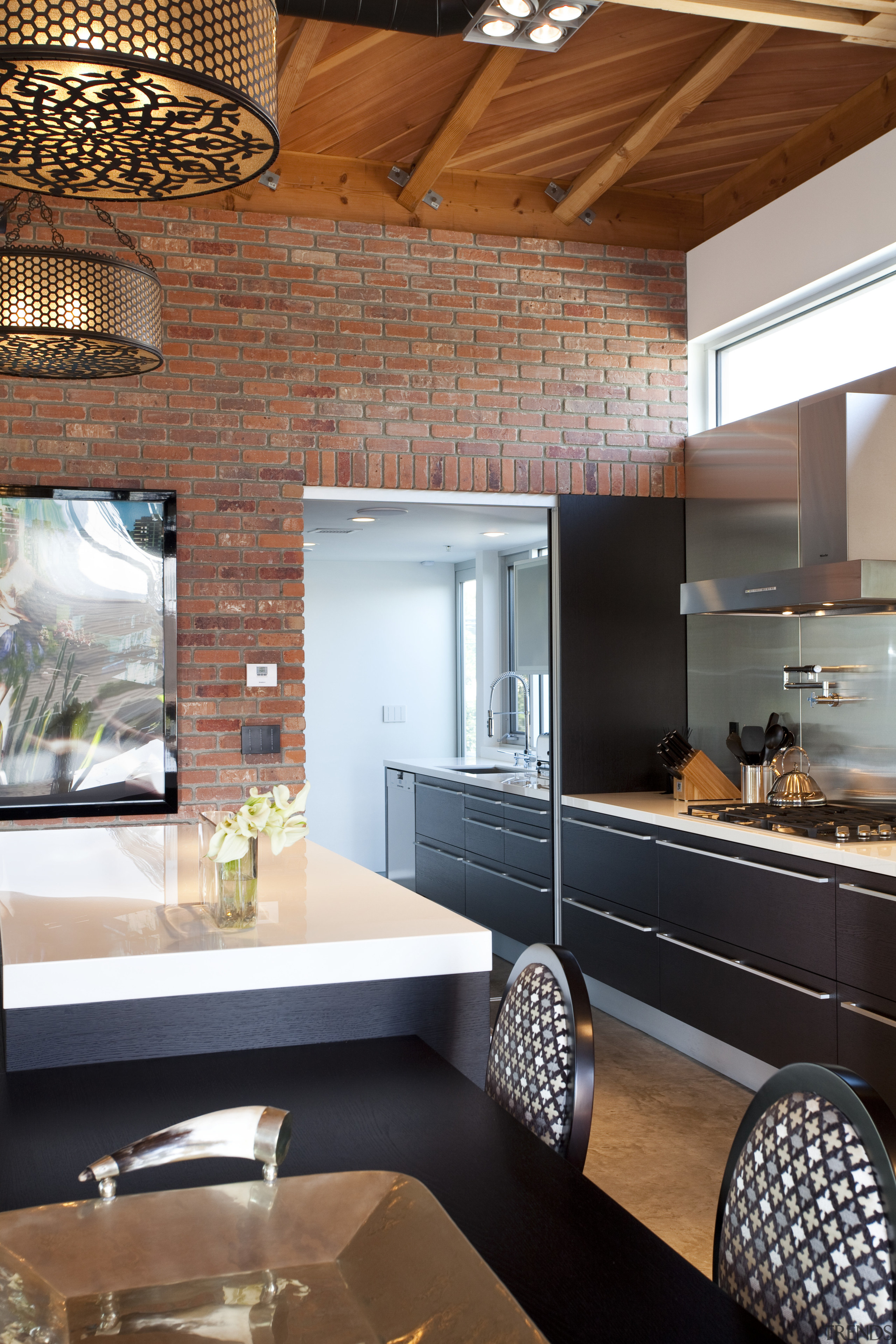 brick walls, decorative chandeliers,  breakfast bar and architecture, cabinetry, ceiling, countertop, interior design, kitchen, brown