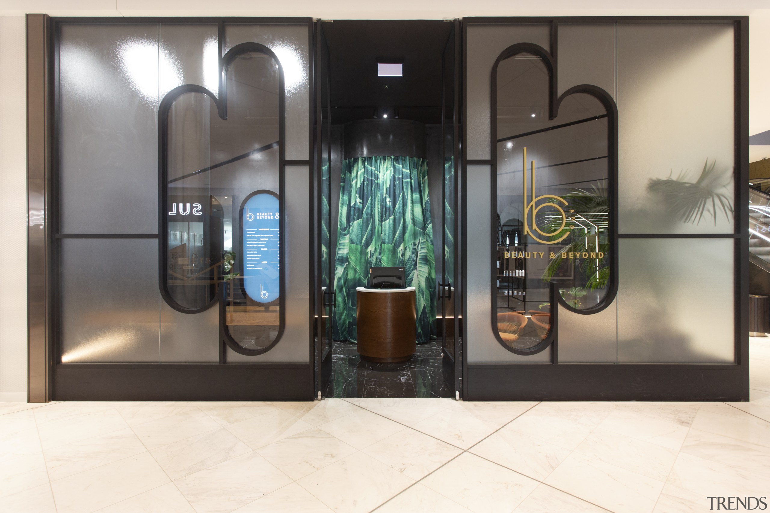 The fit-out emanates a sense of drama before door, furniture, glass, interior design, iron, metal, room, white, black, gray