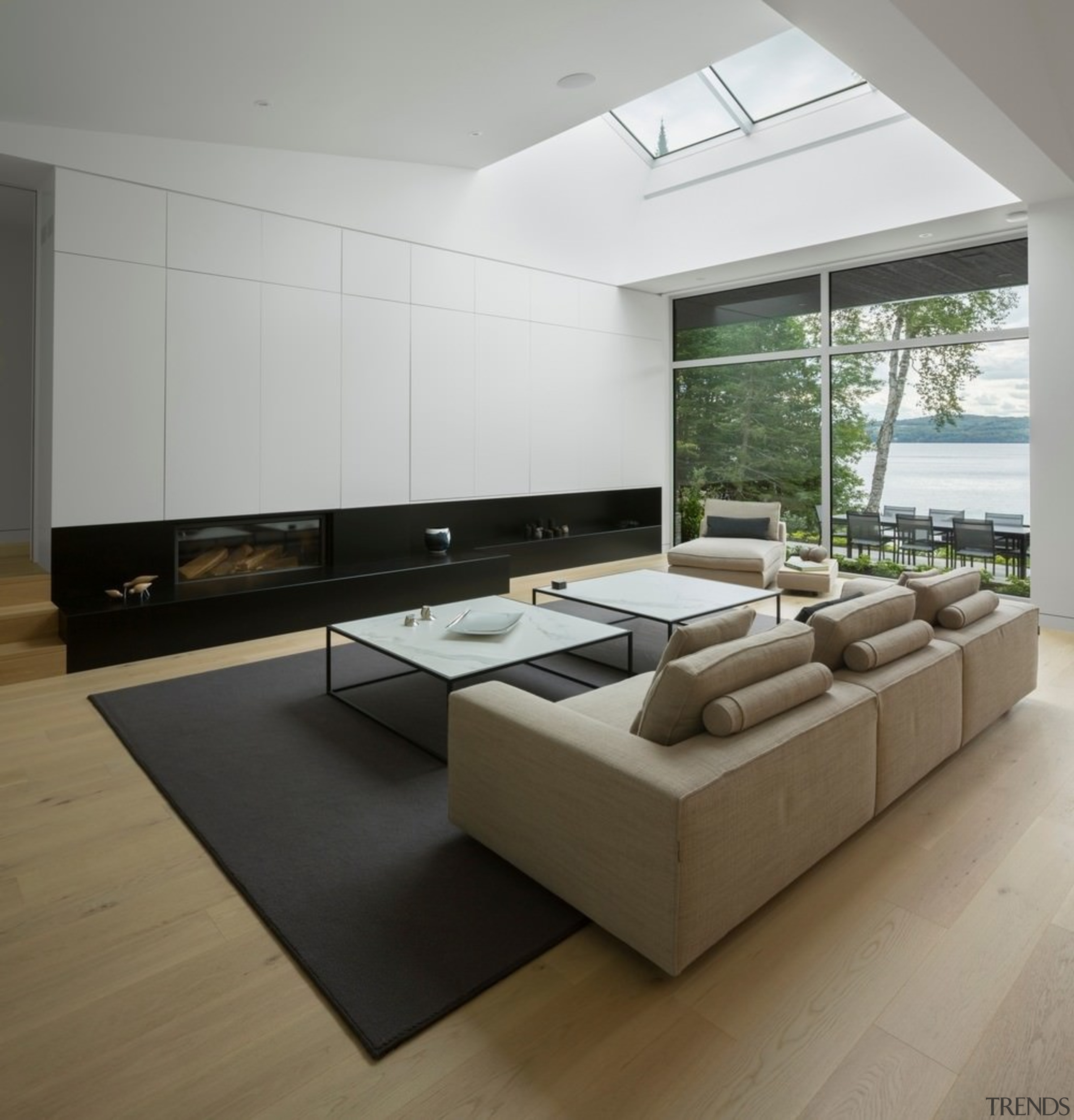 The ceiling angles up to the meet the architecture, floor, flooring, furniture, interior design, living room, product design, table, wood flooring, gray