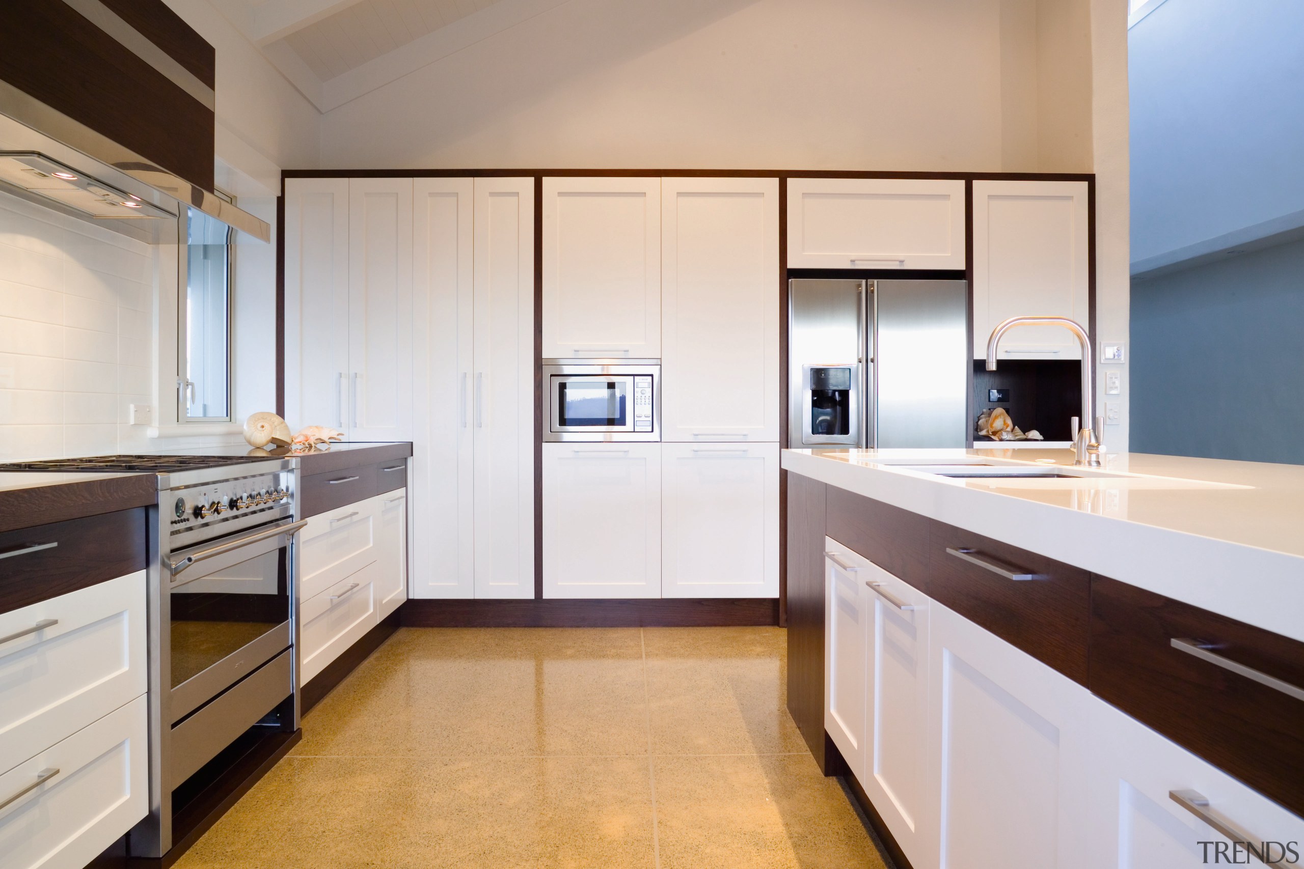 A view of this kitchen featuring laminex caeserstone cabinetry, countertop, cuisine classique, home appliance, interior design, kitchen, real estate, room, gray