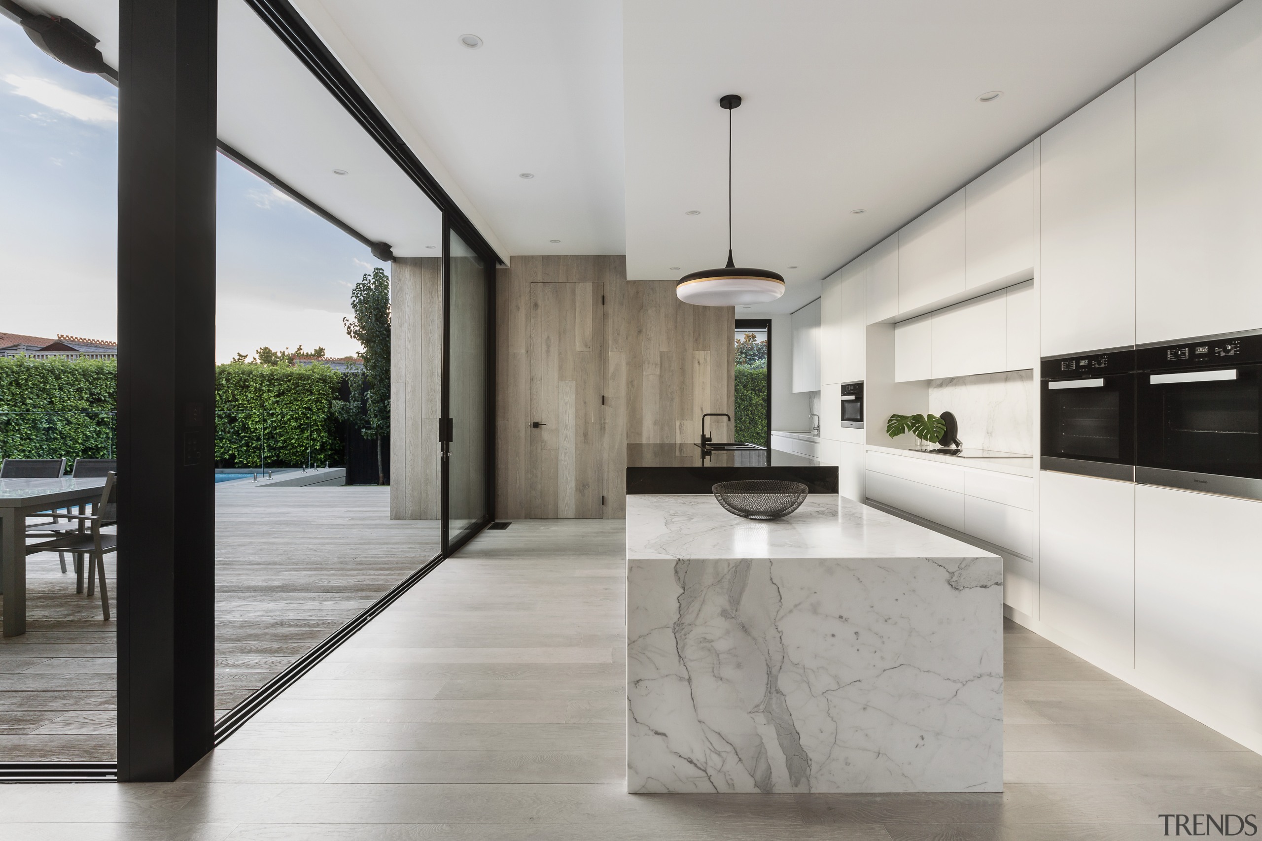 ​​​​​​​On this renovation by LSA Architects, the wood-clad architecture, countertop, benchtop, floor, house, interior design, kitchen, timber, marble, LSA Architects