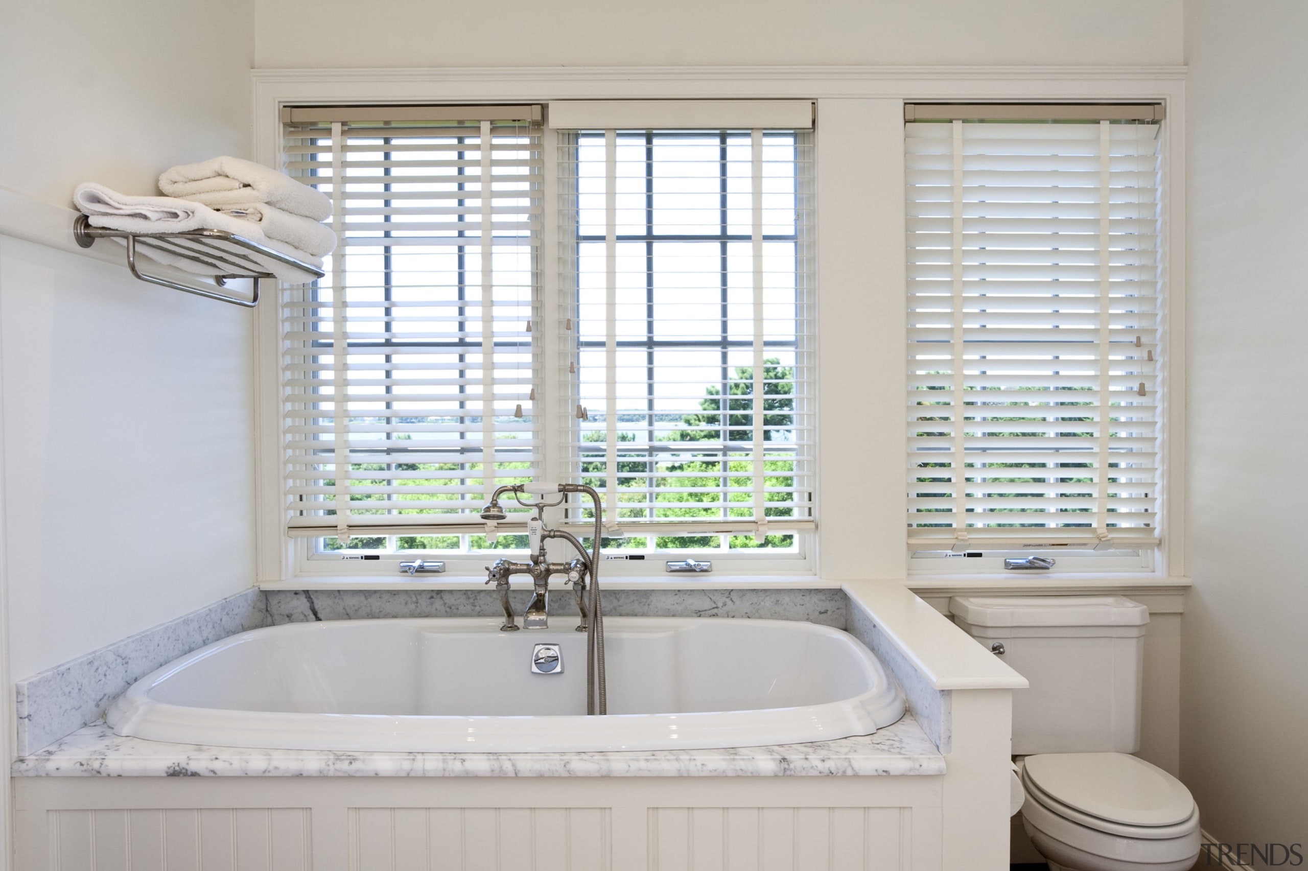View of bathtub with white painted timber surround. bathroom, bathroom accessory, bathtub, estate, home, interior design, property, room, window, window covering, window treatment, gray