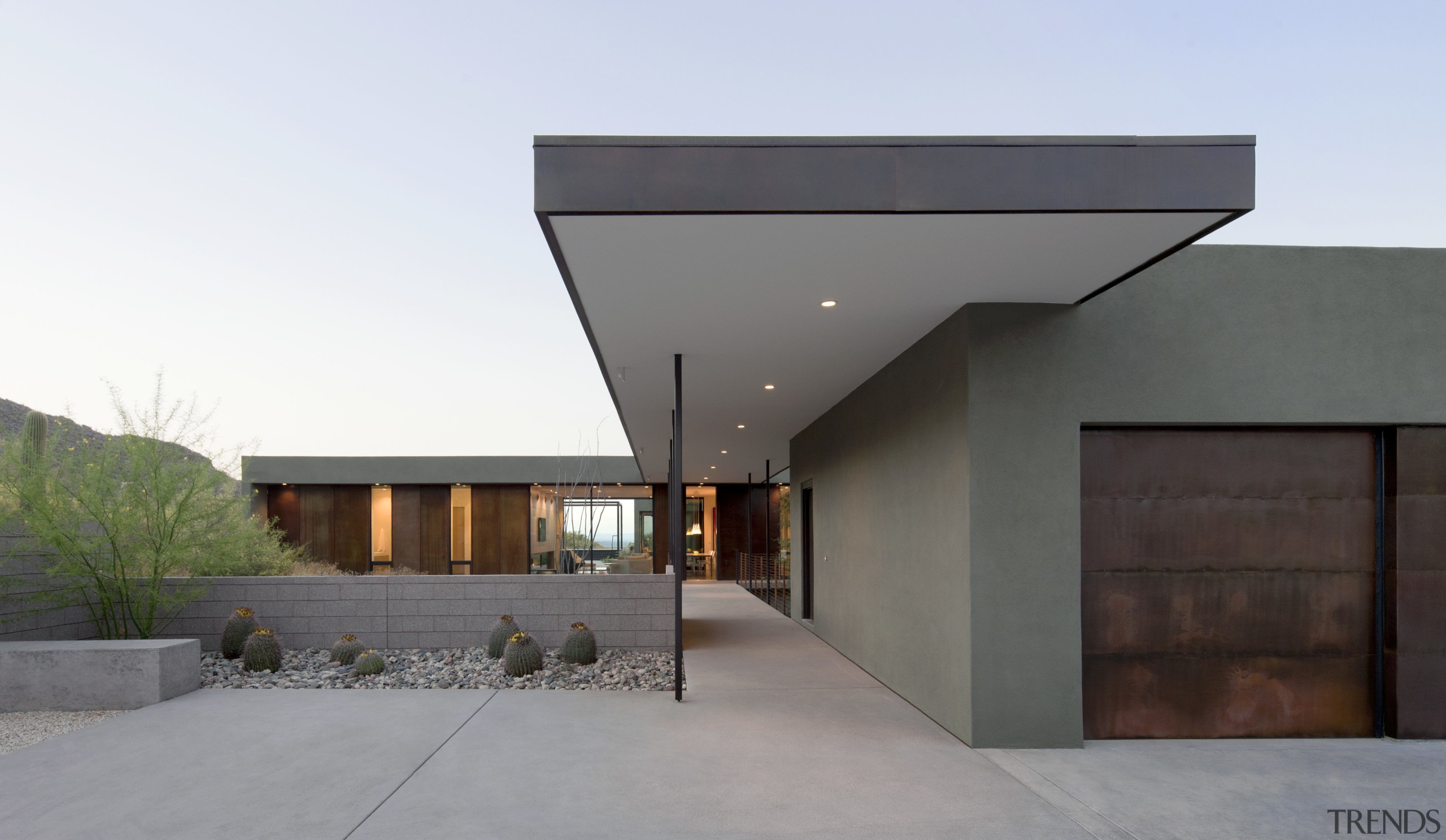 A covered walkway bridges the landscape between the architecture, building, corporate headquarters, facade, home, house, property, real estate, gray, white