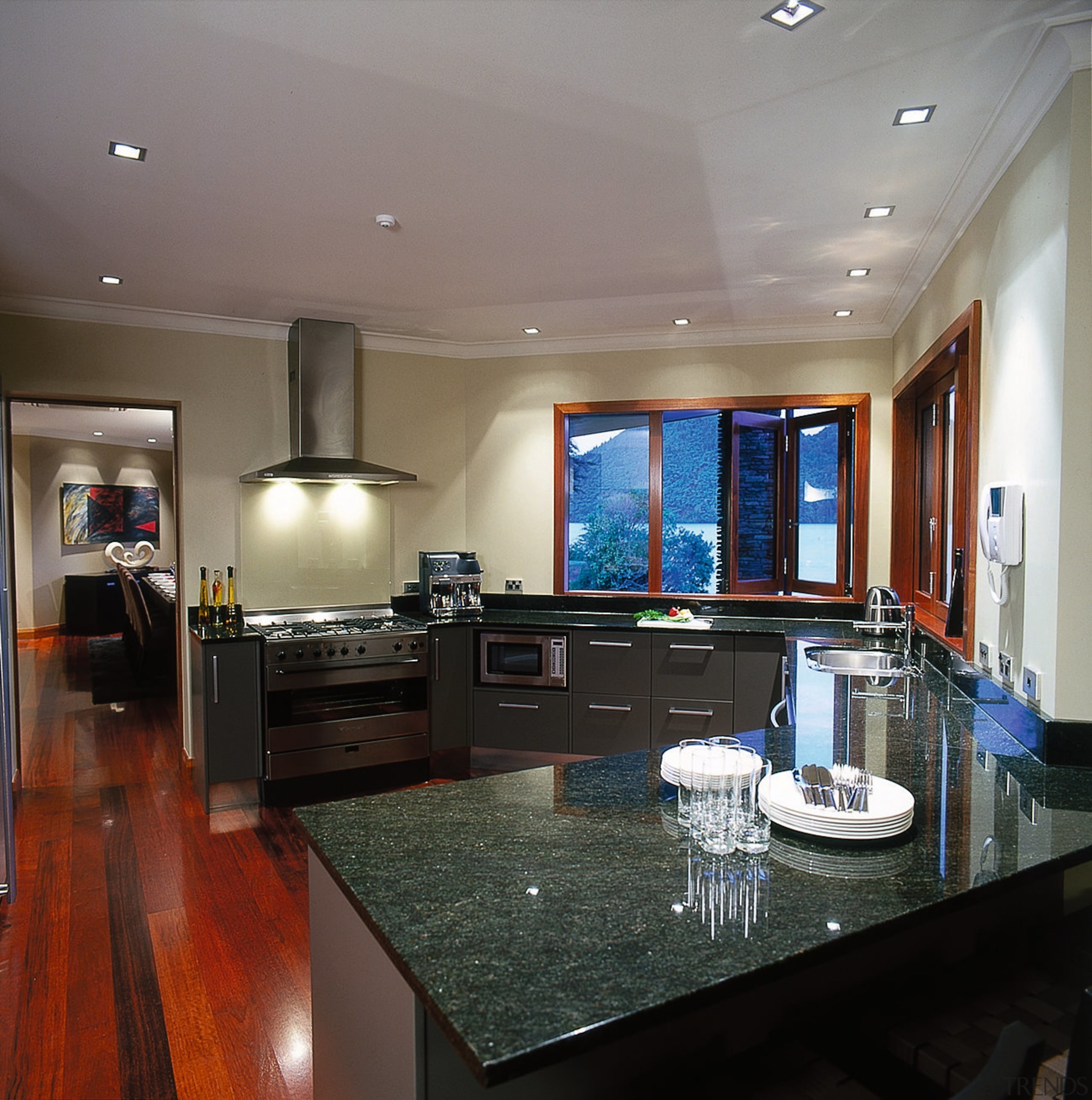 View of the kitchen. Features granite benchtops and ceiling, countertop, floor, interior design, kitchen, living room, real estate, room, gray, black