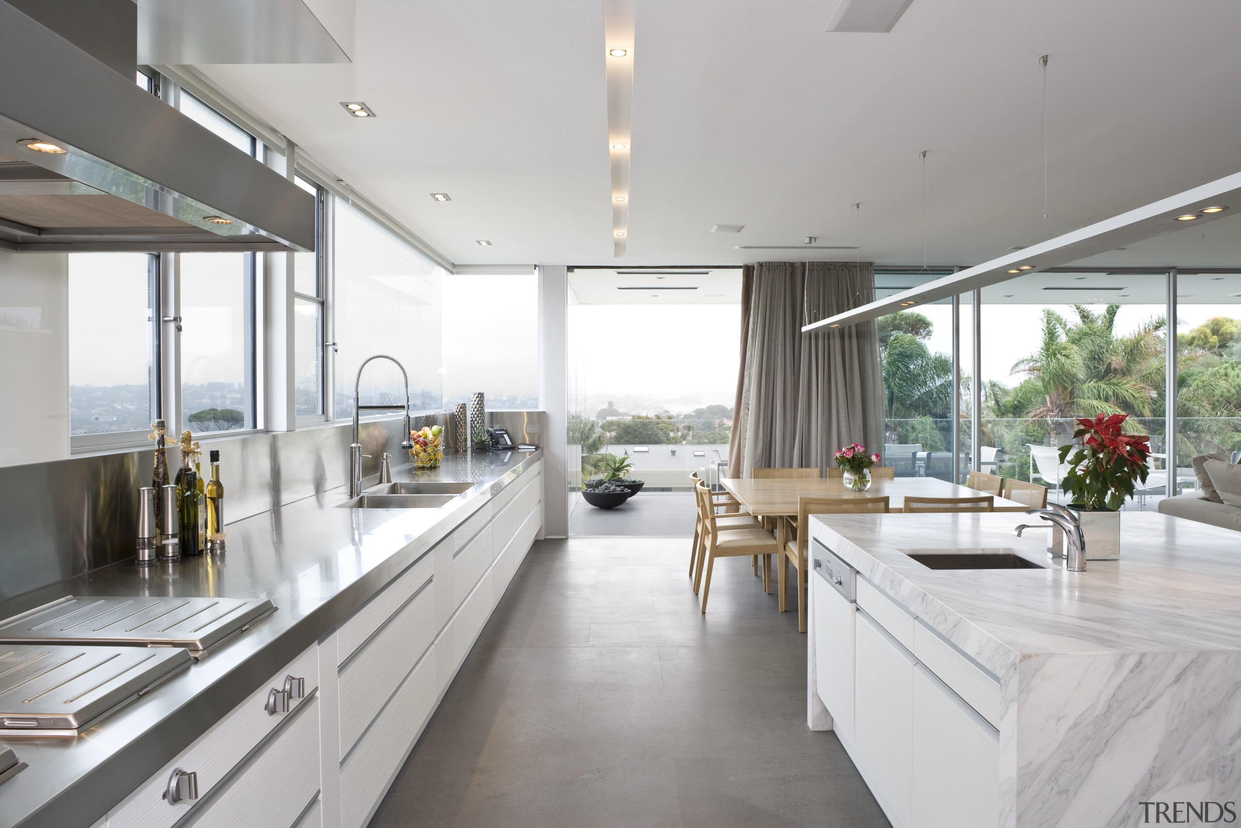 View of the kitchen area which features an architecture, countertop, house, interior design, kitchen, real estate, window, white, gray