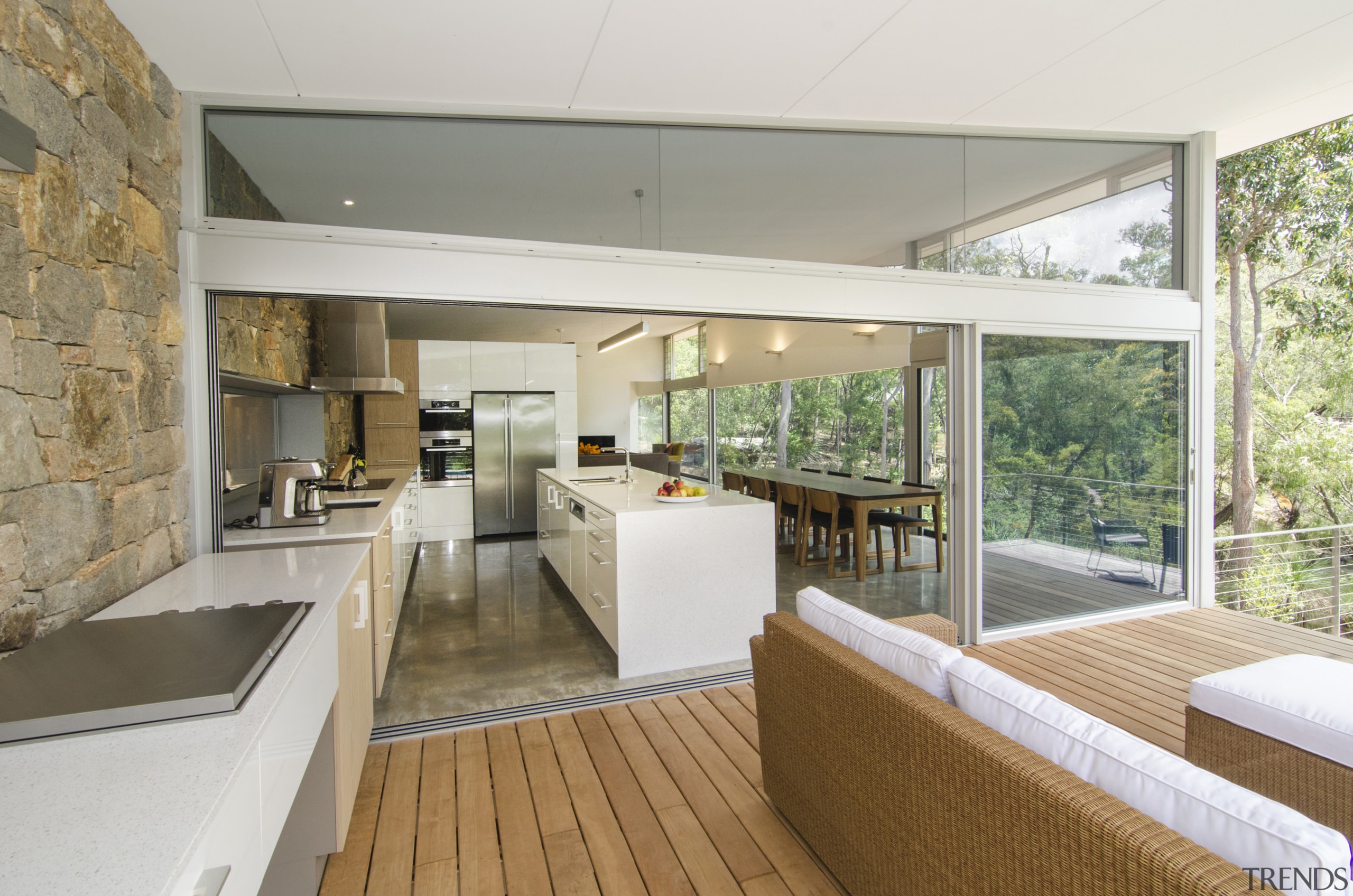 This galley-style kitchen extends through to a covered architecture, house, interior design, real estate, white