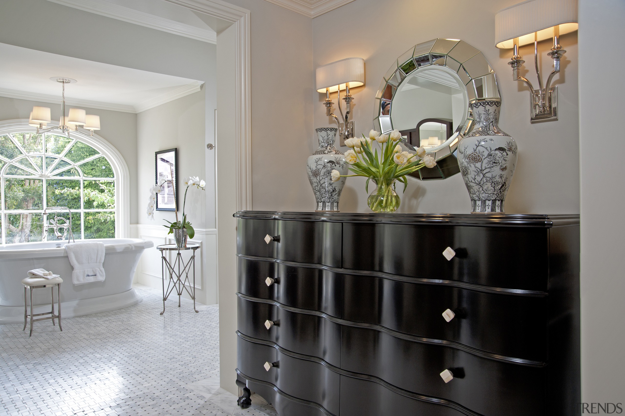 View of dark set of drawers with circular cabinetry, chest of drawers, dining room, floor, flooring, furniture, home, interior design, living room, room, table, wall, gray