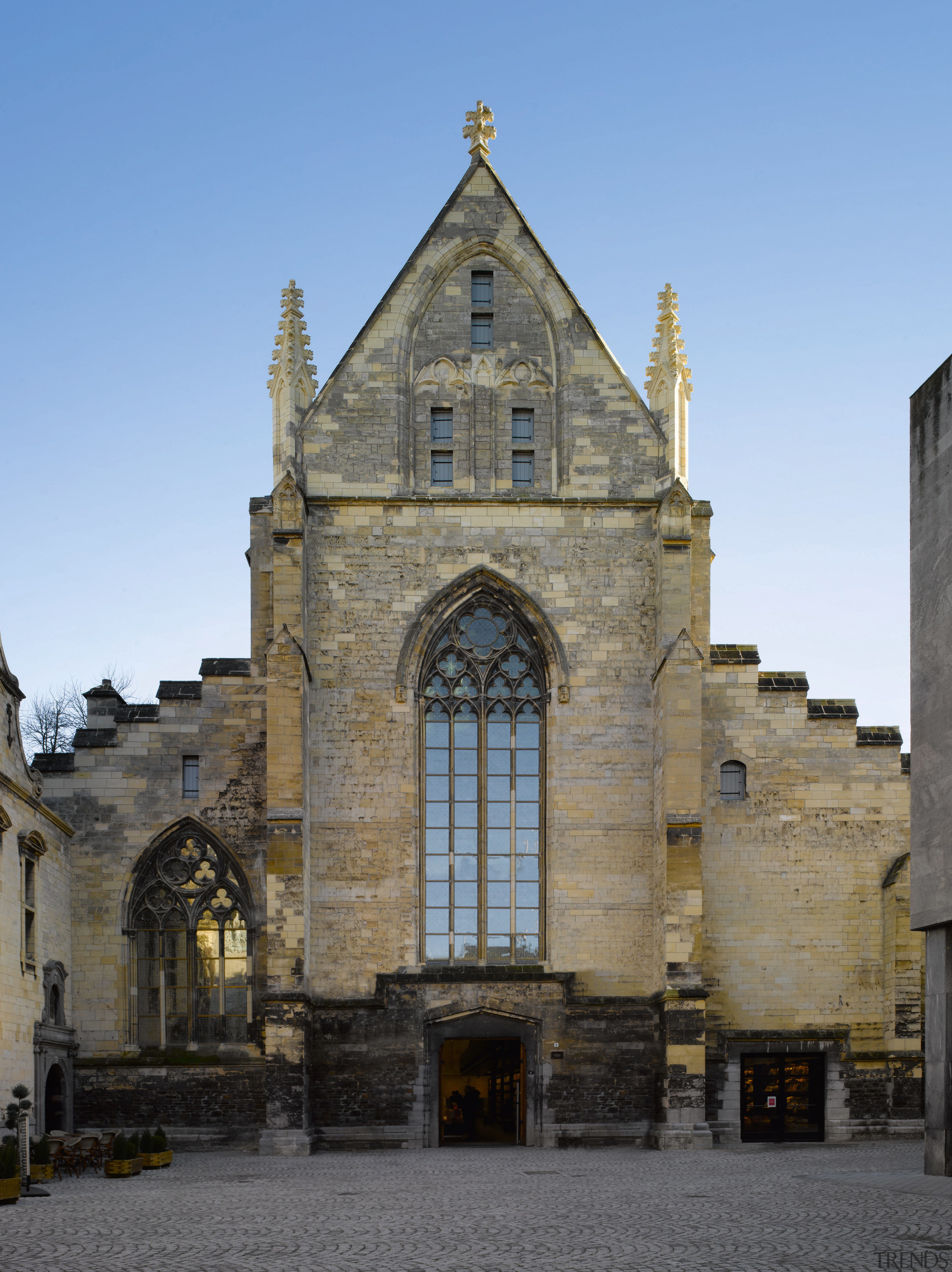 The church exterior gives little indication of transformation abbey, baptistery, basilica, bell tower, building, cathedral, chapel, church, classical architecture, facade, historic site, history, listed building, medieval architecture, middle ages, parish, place of worship, sky, spire, steeple, window, teal, gray