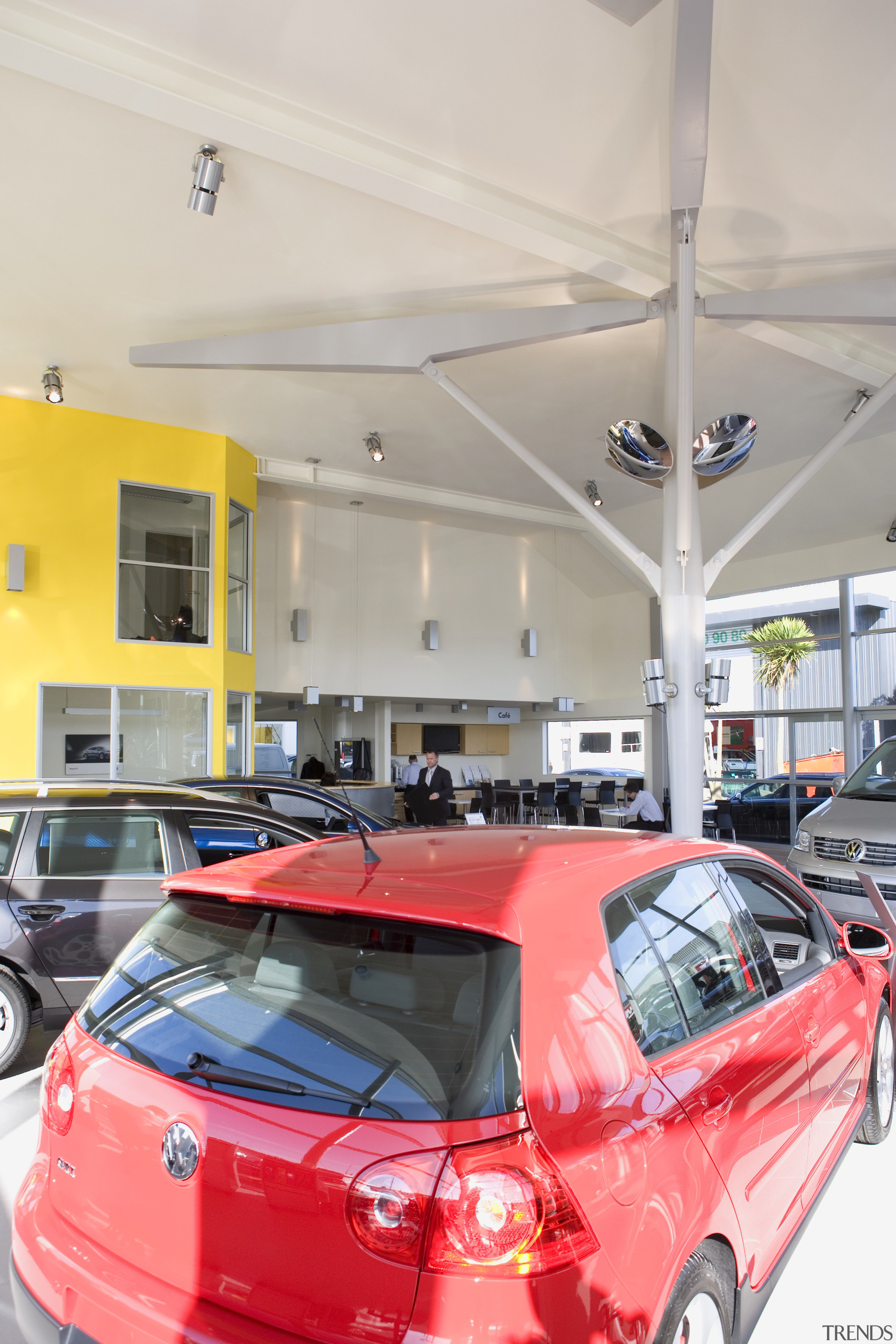 View of Tristram European's new VW showroom which auto part, automotive design, automotive exterior, building, car, car dealership, family car, mid size car, motor vehicle, parking, red, vehicle, vehicle door, gray