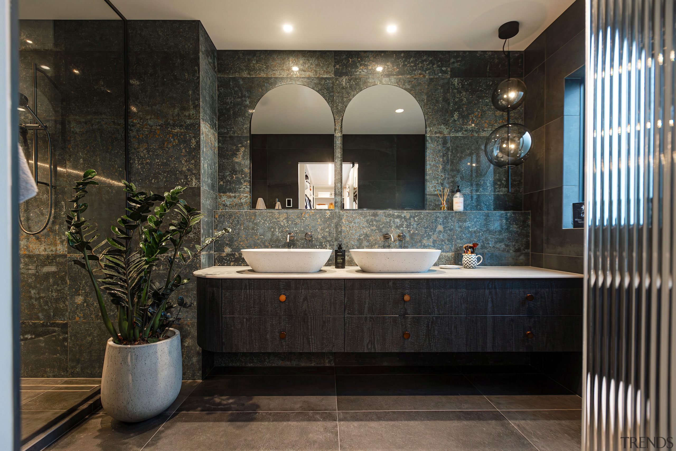 The bathroom has a moody meets natural vibe. 